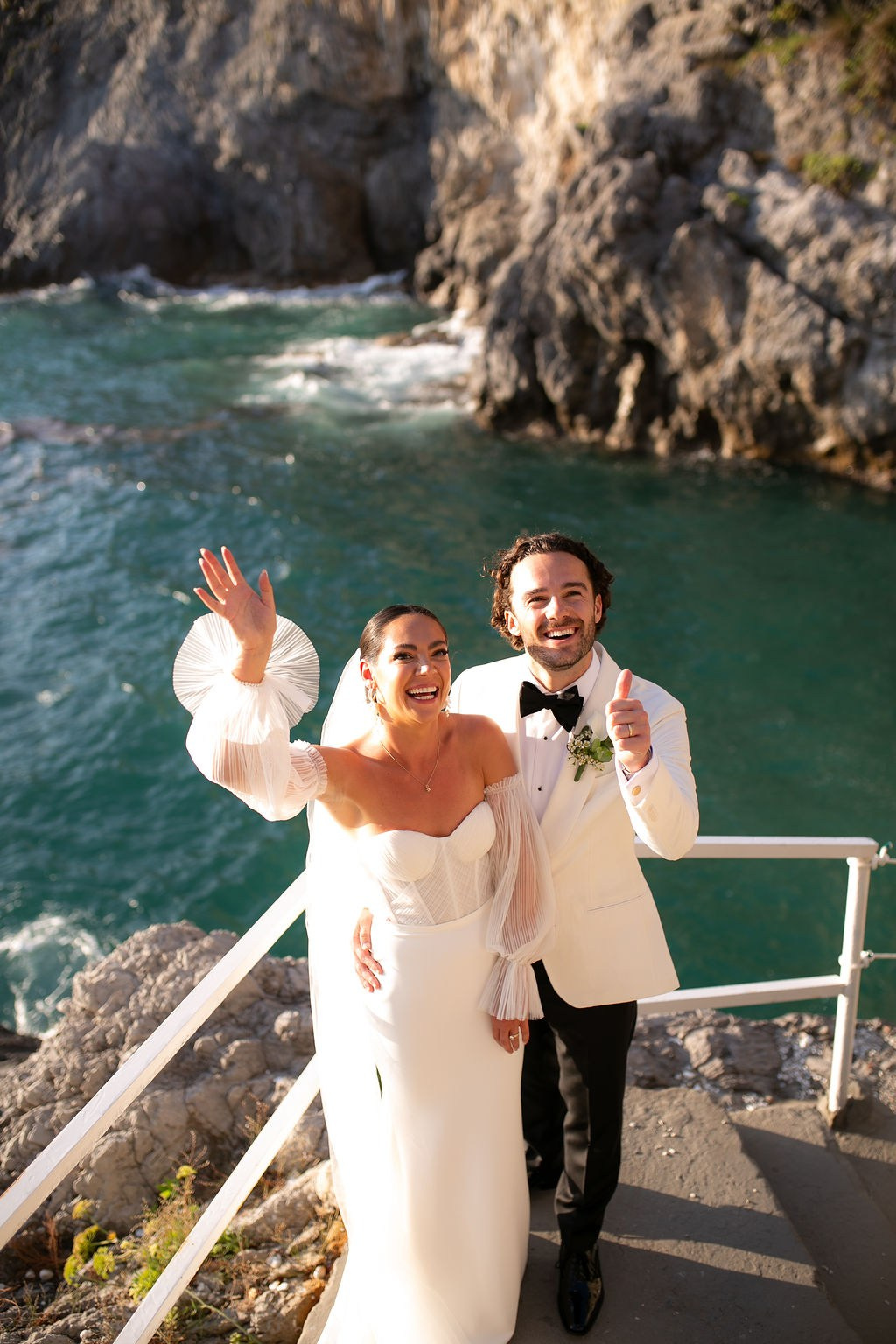 Bride and groom celebrating aboard a yacht during a destination wedding in Italy