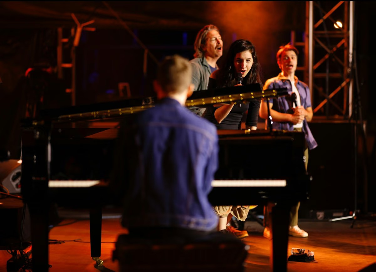 Singer and pianist performing live at an evening corporate event