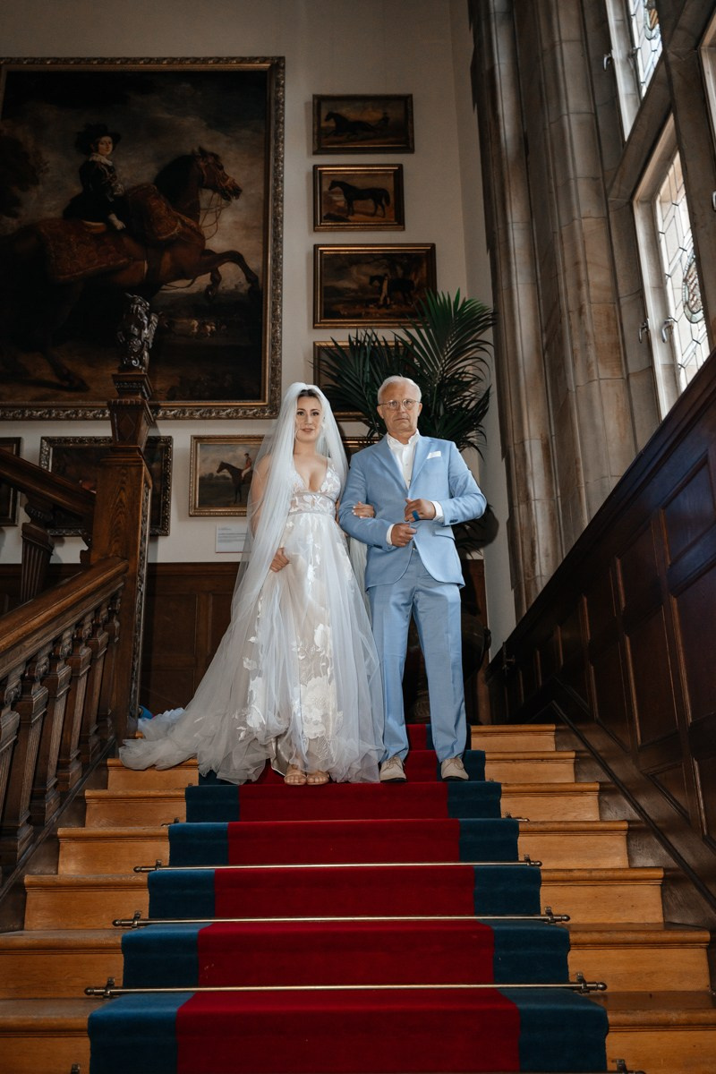 bride with her father at stairs before first look