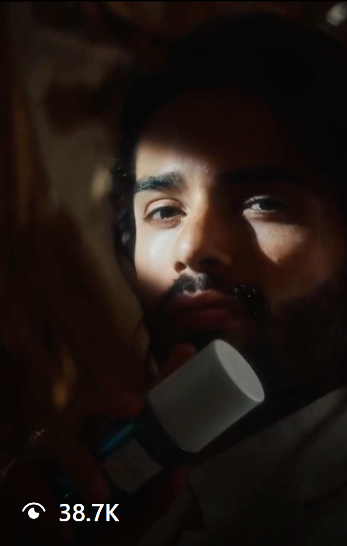 Renan Pacheco in a dramatic close-up, holding a skincare product, with soft lighting highlighting his face. A perfect showcase of modern beauty campaigns and sustainable branding.