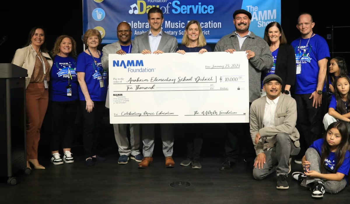 Community group presenting an oversized cheque during an awards event