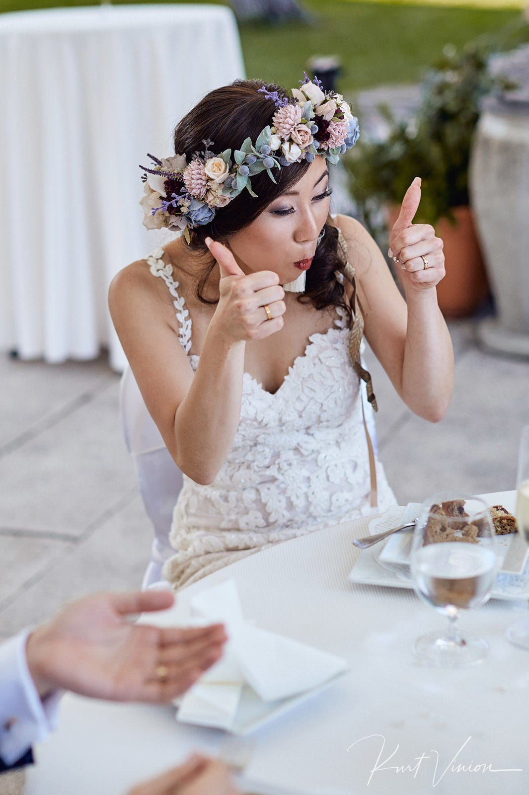 Joyful bride giving thumbs up appreciating traditional Bled cake.
