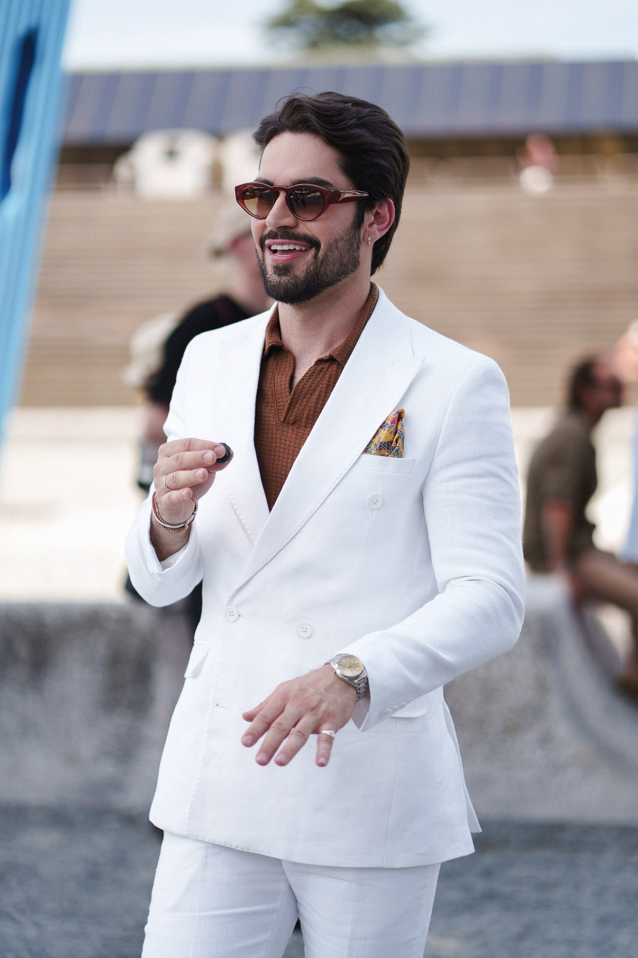 Pitti Uomo 110 street style portrait, man in white double-breasted blazer and brown shirt
