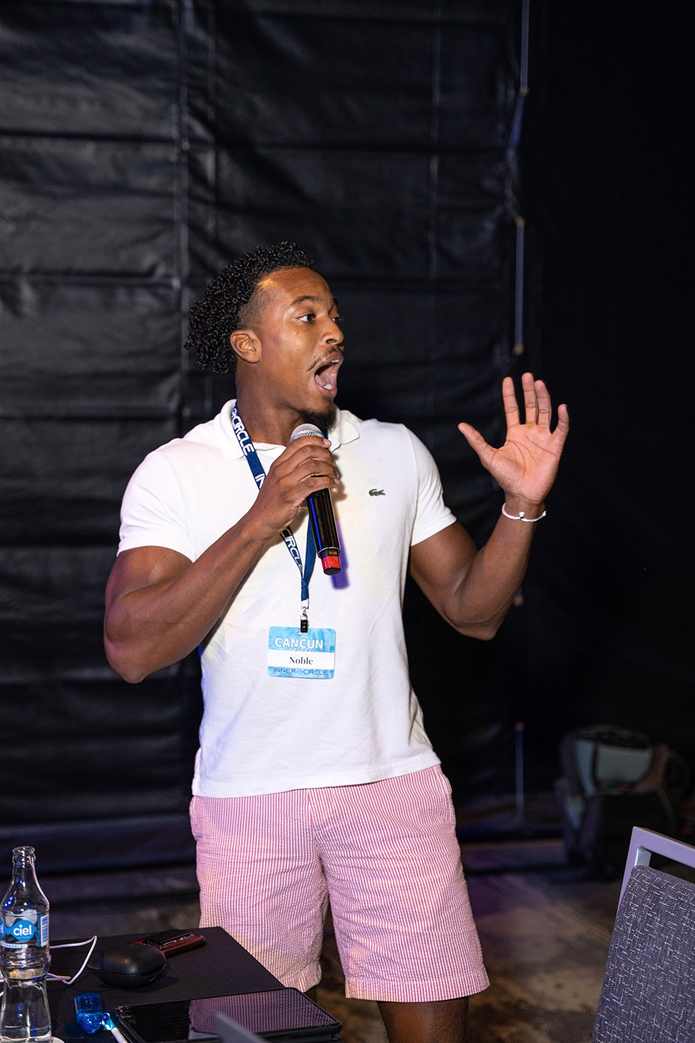 Attendee using microphone to clarify topic with presenter.