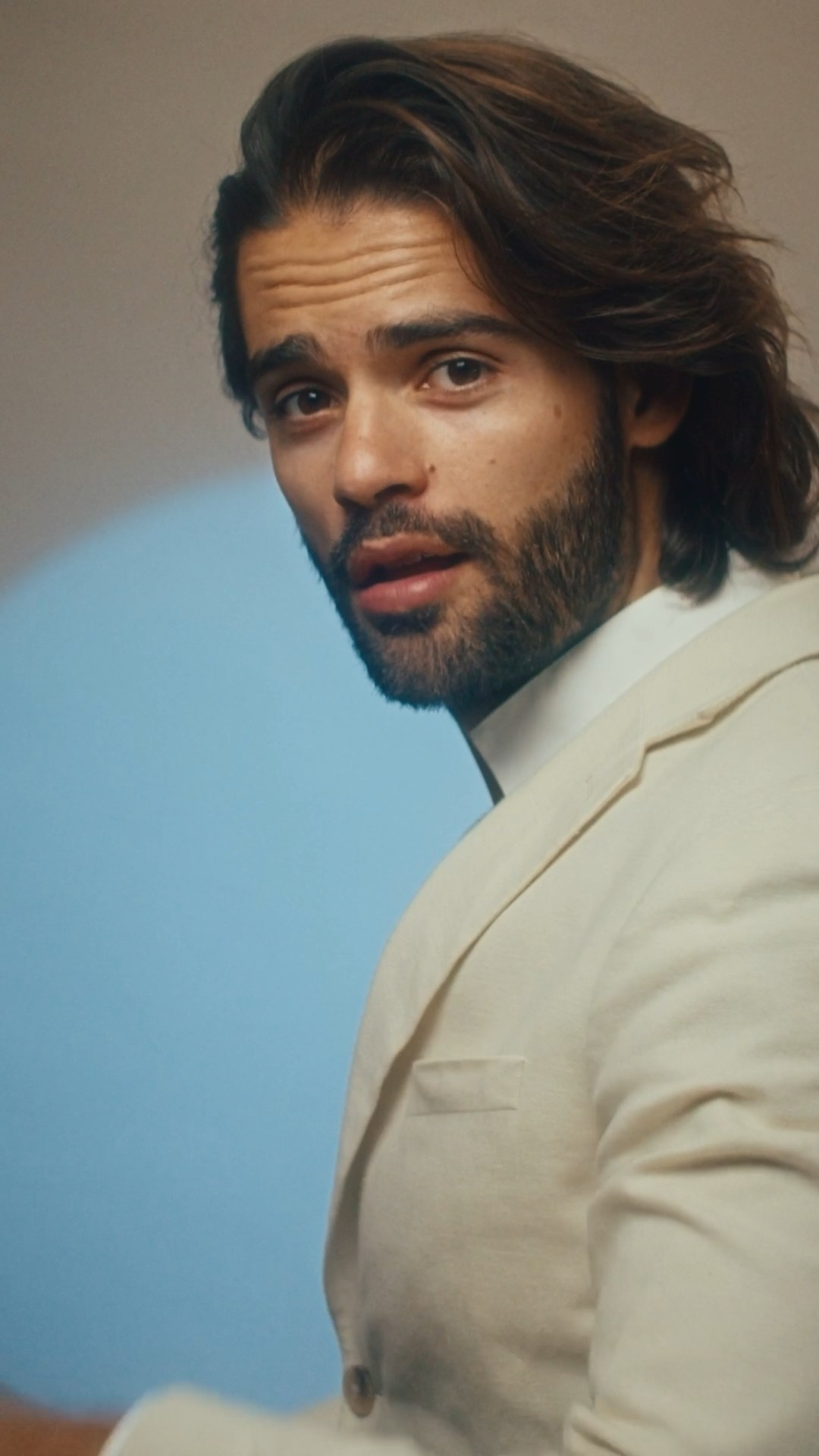 Male model wearing a tailored beige suit, showcasing modern menswear for a fashion campaign.