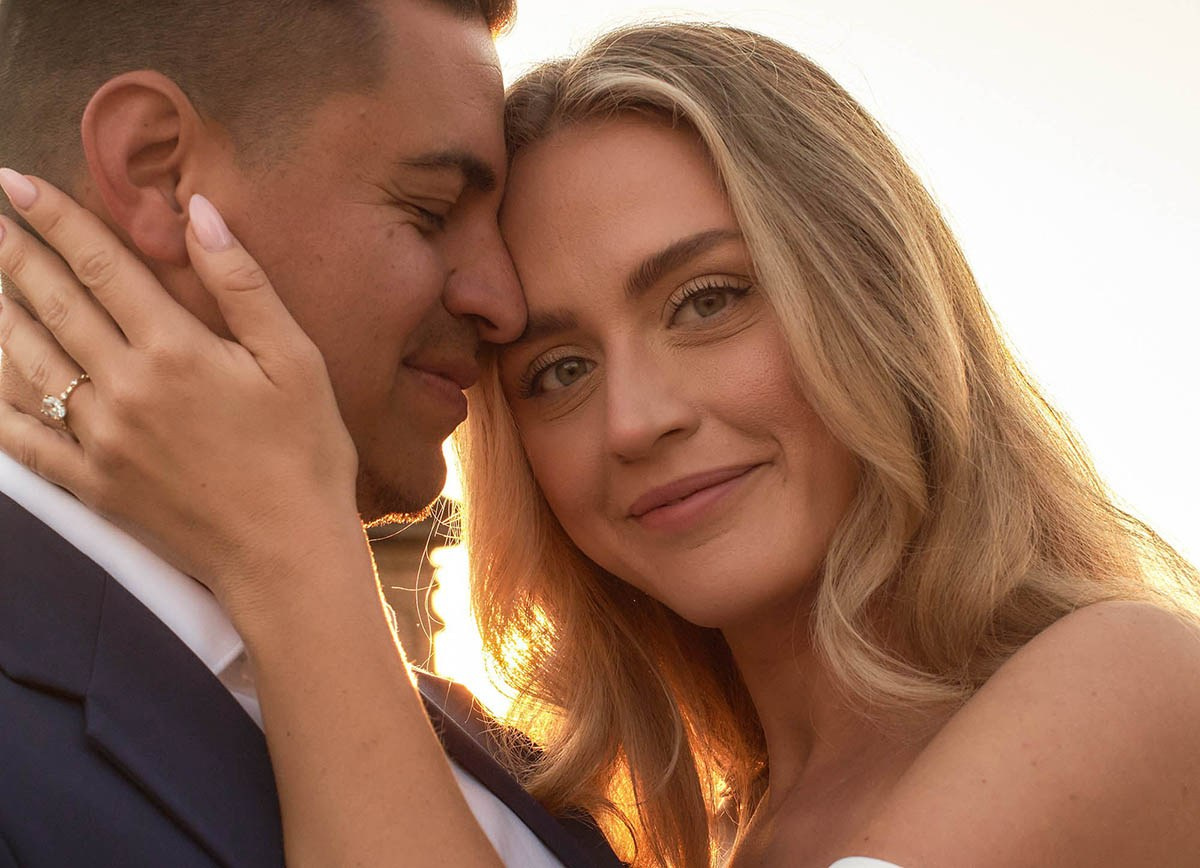 Couple embrace Charles Bridge sunrise closeup portrait