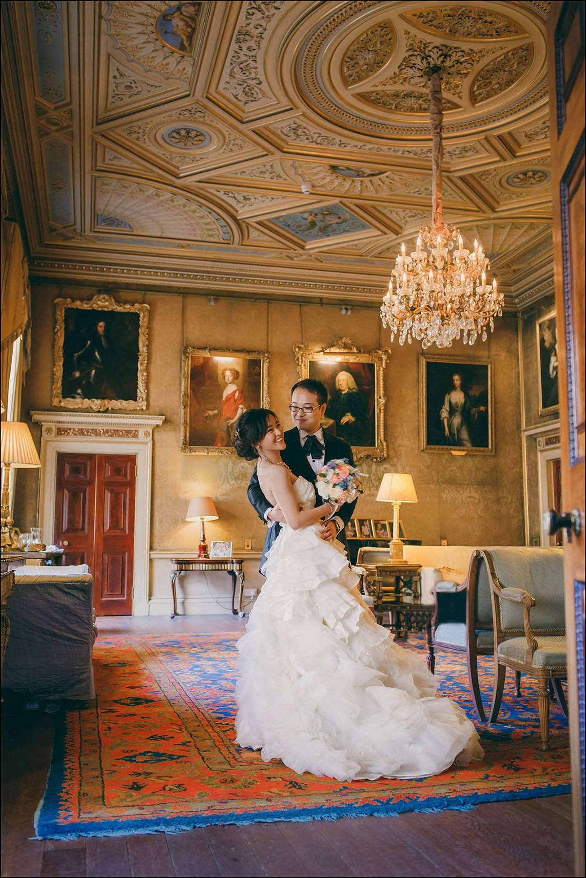 A smiling bride and groom captured in the historic Syon House in London during their destination wedding.