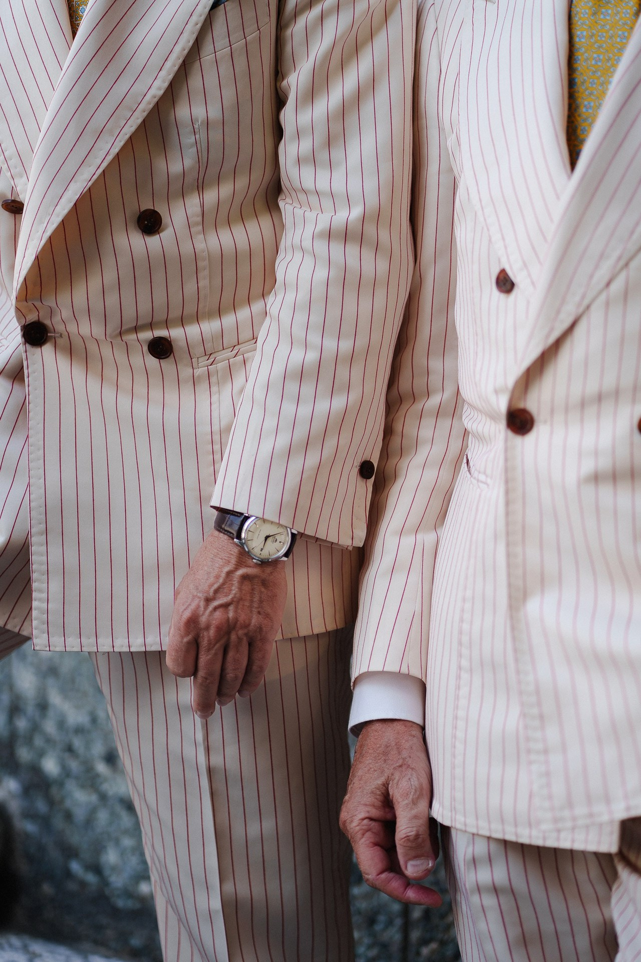 Tailoring detail from Pitti Uomo 110, cream striped double-breasted suit and watch in Florence