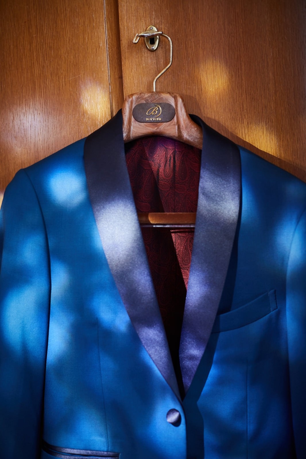 Groom's blue tuxedo hanging in suite Vila Bled Lake Bled wedding.