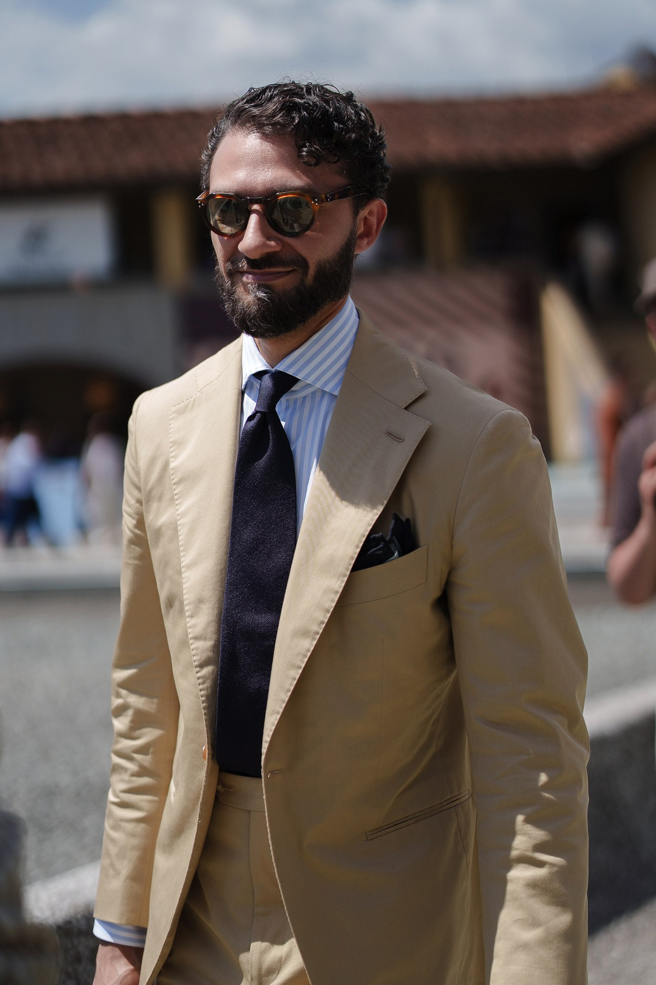 Street style portrait at Pitti Uomo 110, man in beige suit and sunglasses in Florence