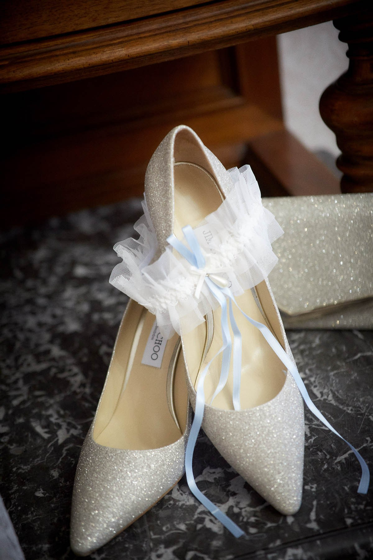 The bride's Jimmy Choo shoes and garter await in her hotel room.