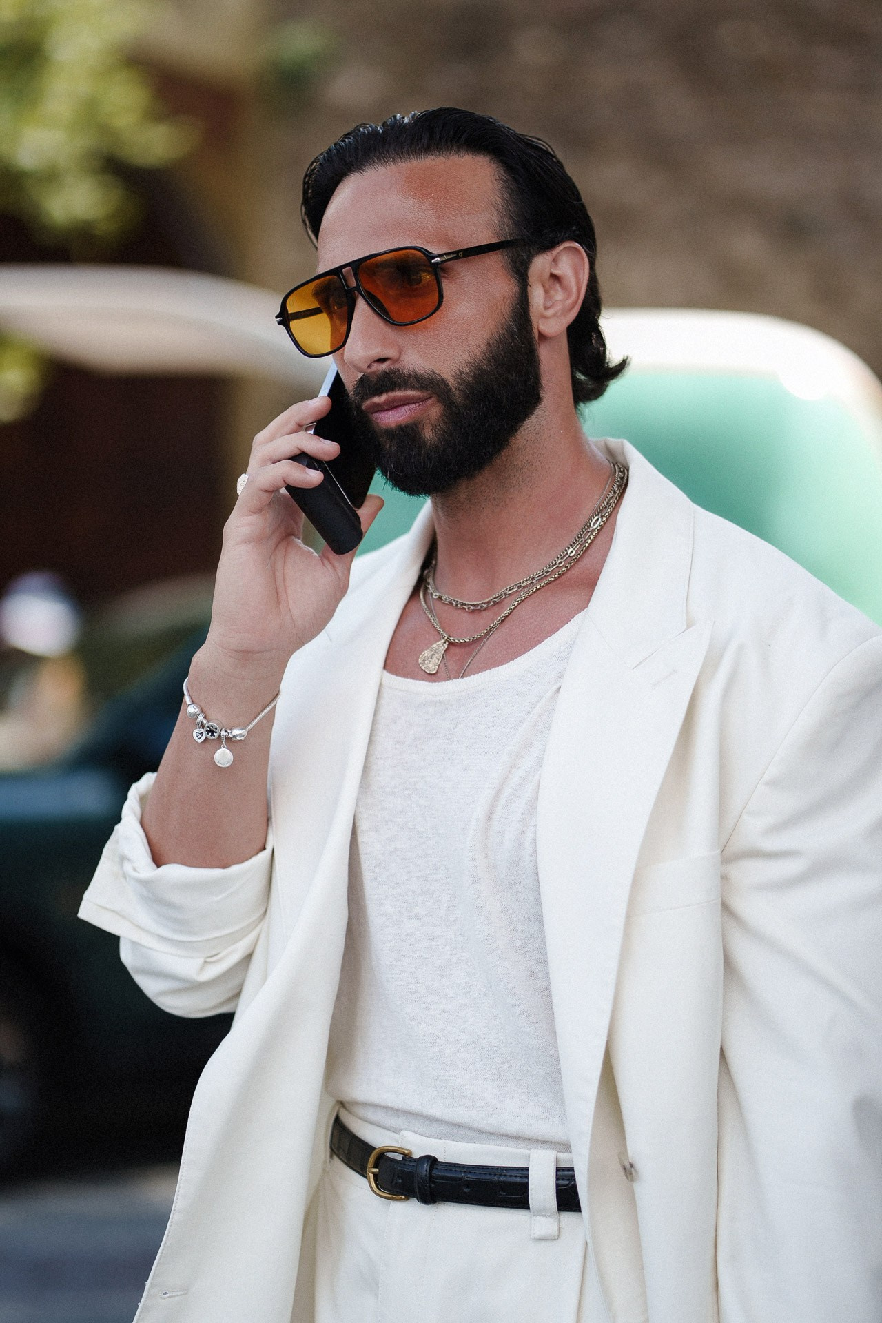 Pitti Uomo 110 street style portrait, guest in white summer suit speaking on the phone