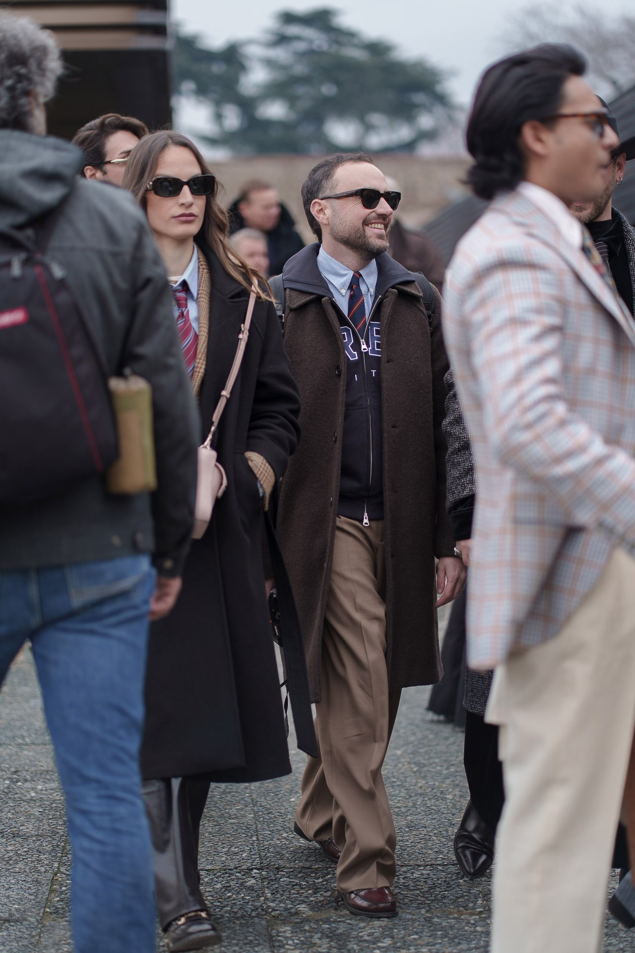 Crowd of stylish people walking outside Pitti Uomo 109 Florence street style