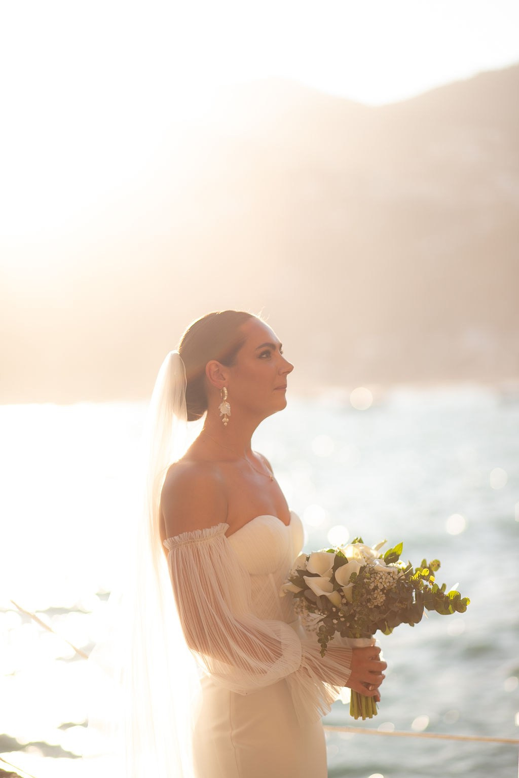 Bride holding her bouquet at sunset during a destination wedding on the Amalfi Coast