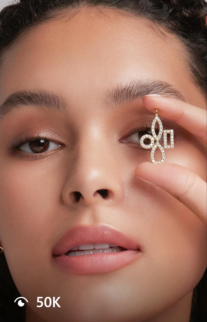 Close-up of a model holding a sparkling diamond pendant from Mavie jewelry, showcasing timeless elegance and modern craftsmanship.