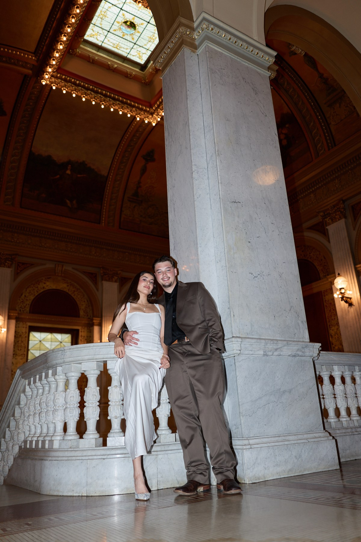 Couple posing beside a grand column at the Ohio Statehouse, Columbus