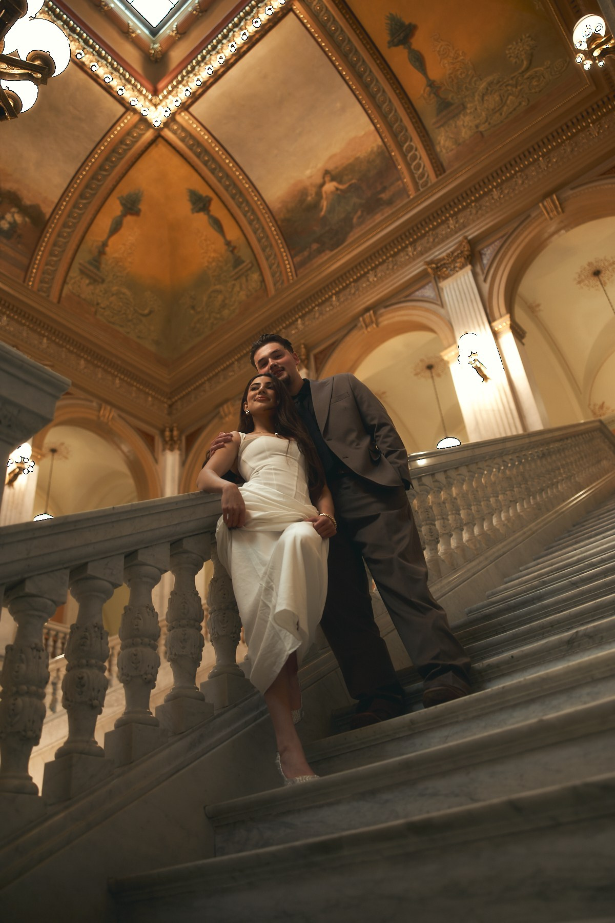 Engaged pair on a staircase landing at the Ohio Statehouse in Columbus