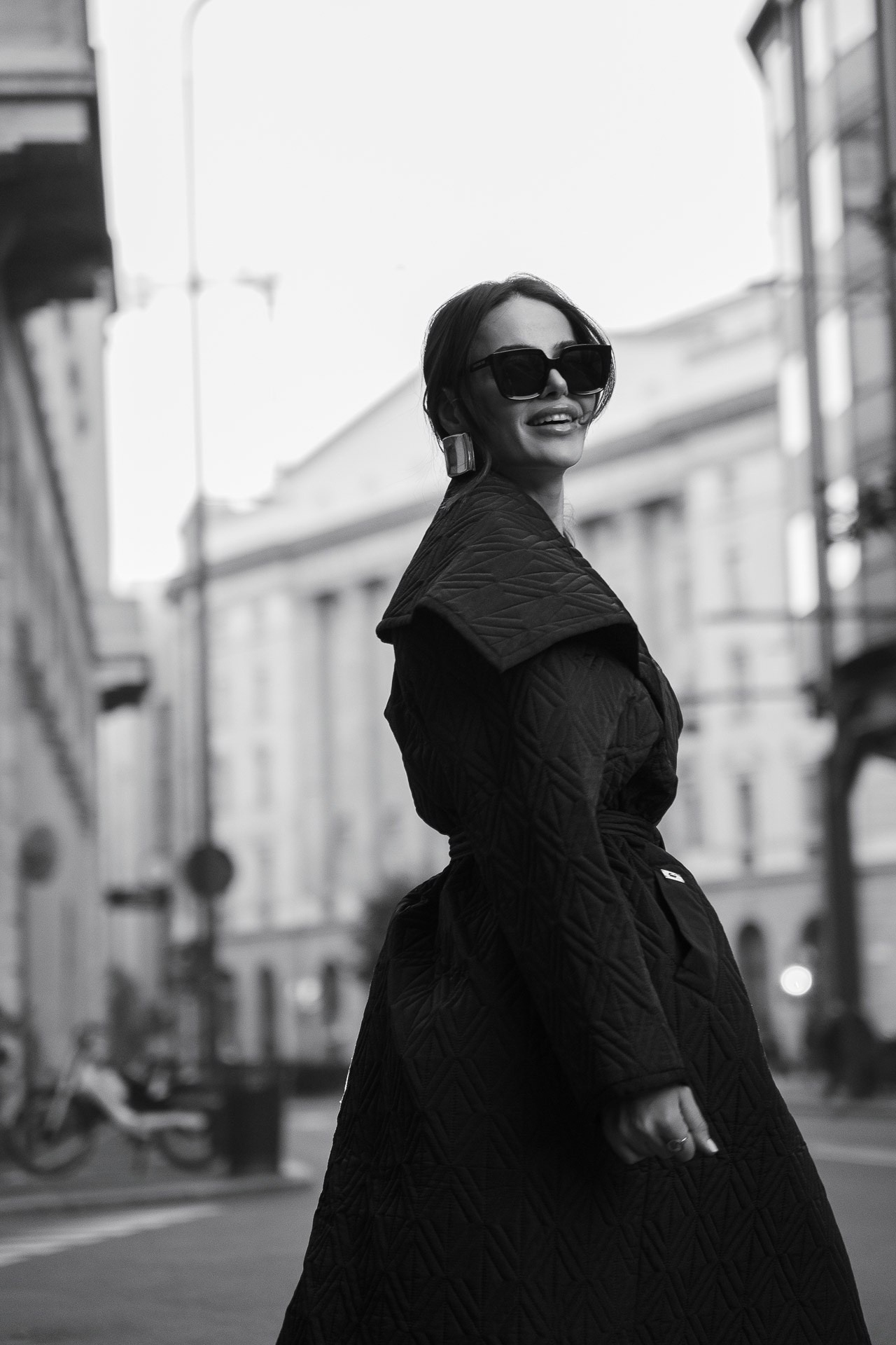 Candid black and white fashion portrait in Milan city center. High-end personal branding and lifestyle photography.