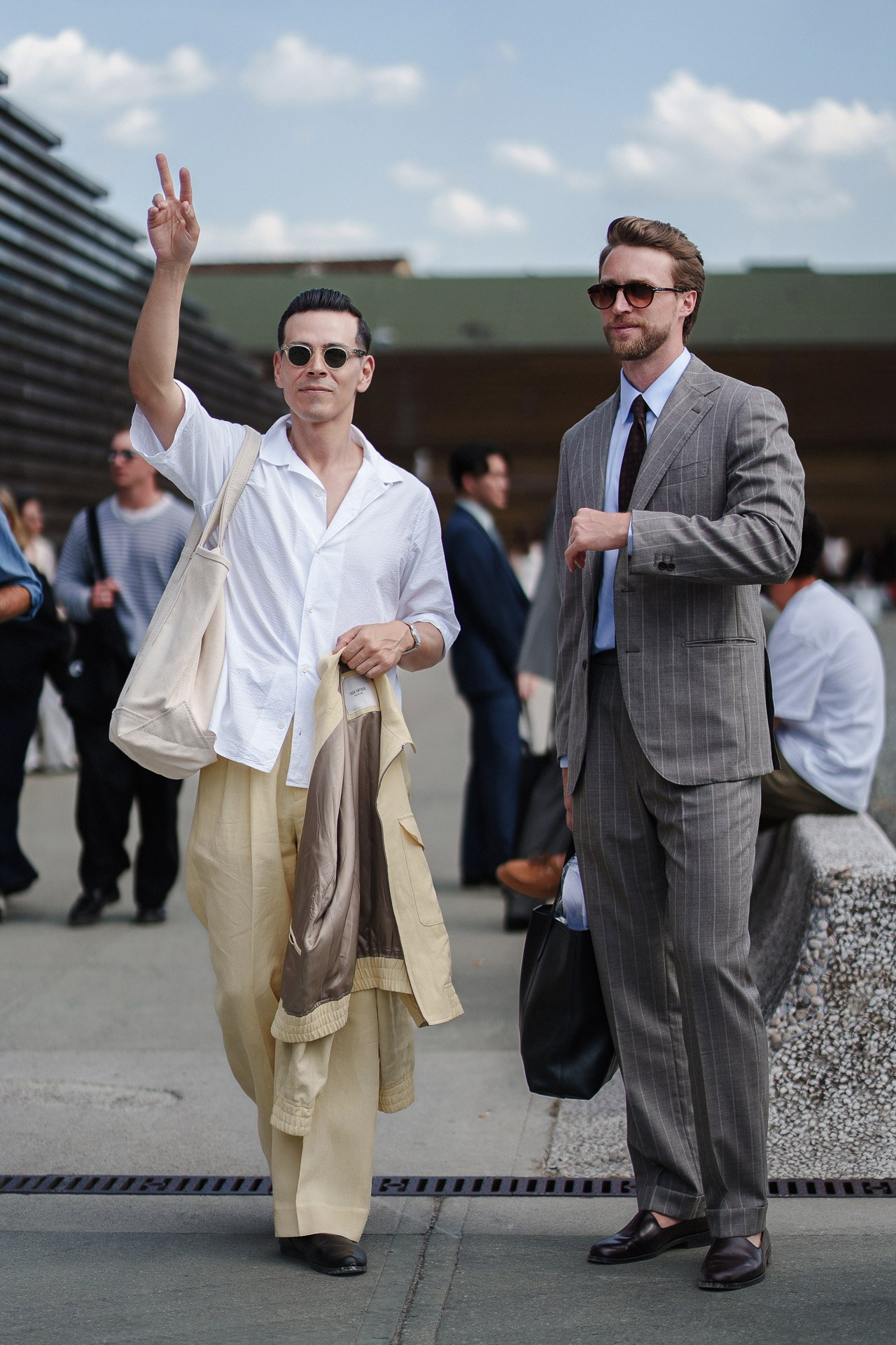 Pitti Uomo 110 guests arriving in relaxed summer menswear outside Fortezza da Basso