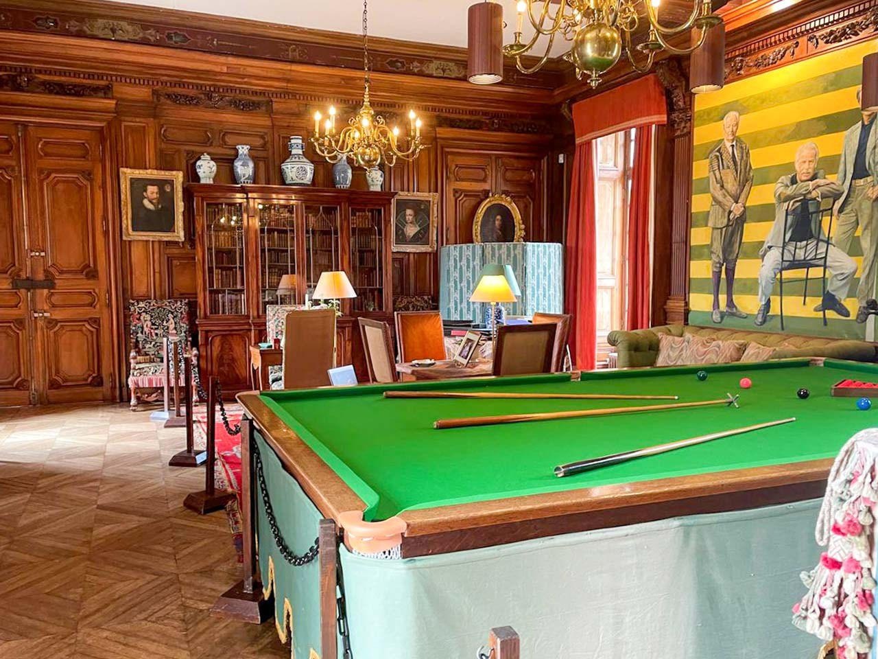 Historic billiard room with wood paneling inside Château de Courances, France