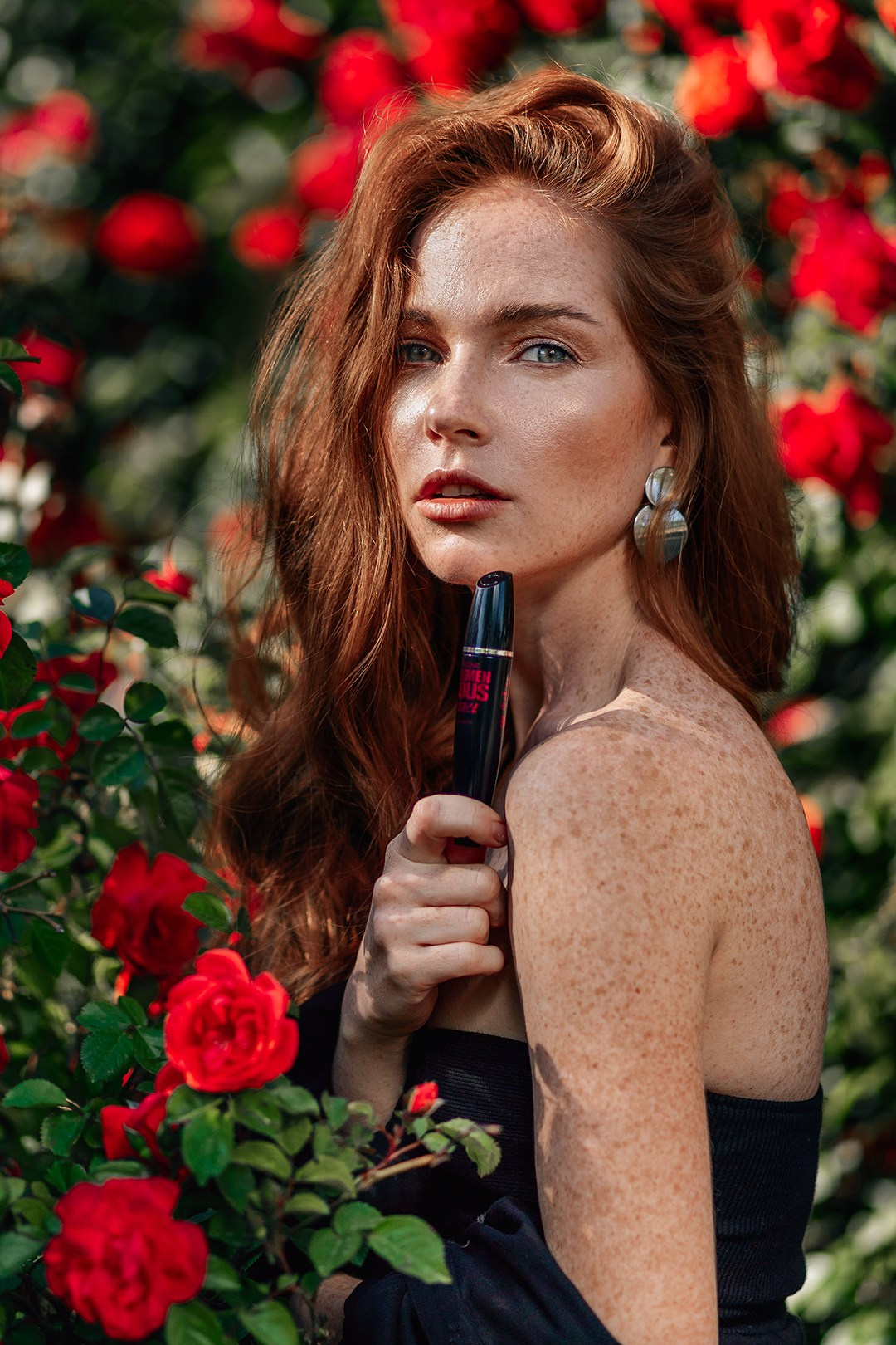 Model with bright lipstick, drawing attention to her full and well-defined lips. Her makeup is bold, creating a striking contrast with her natural features. The background is simple, allowing her lips and expressive eyes to be the focal points. This photograph captures the power of makeup to make a statement.