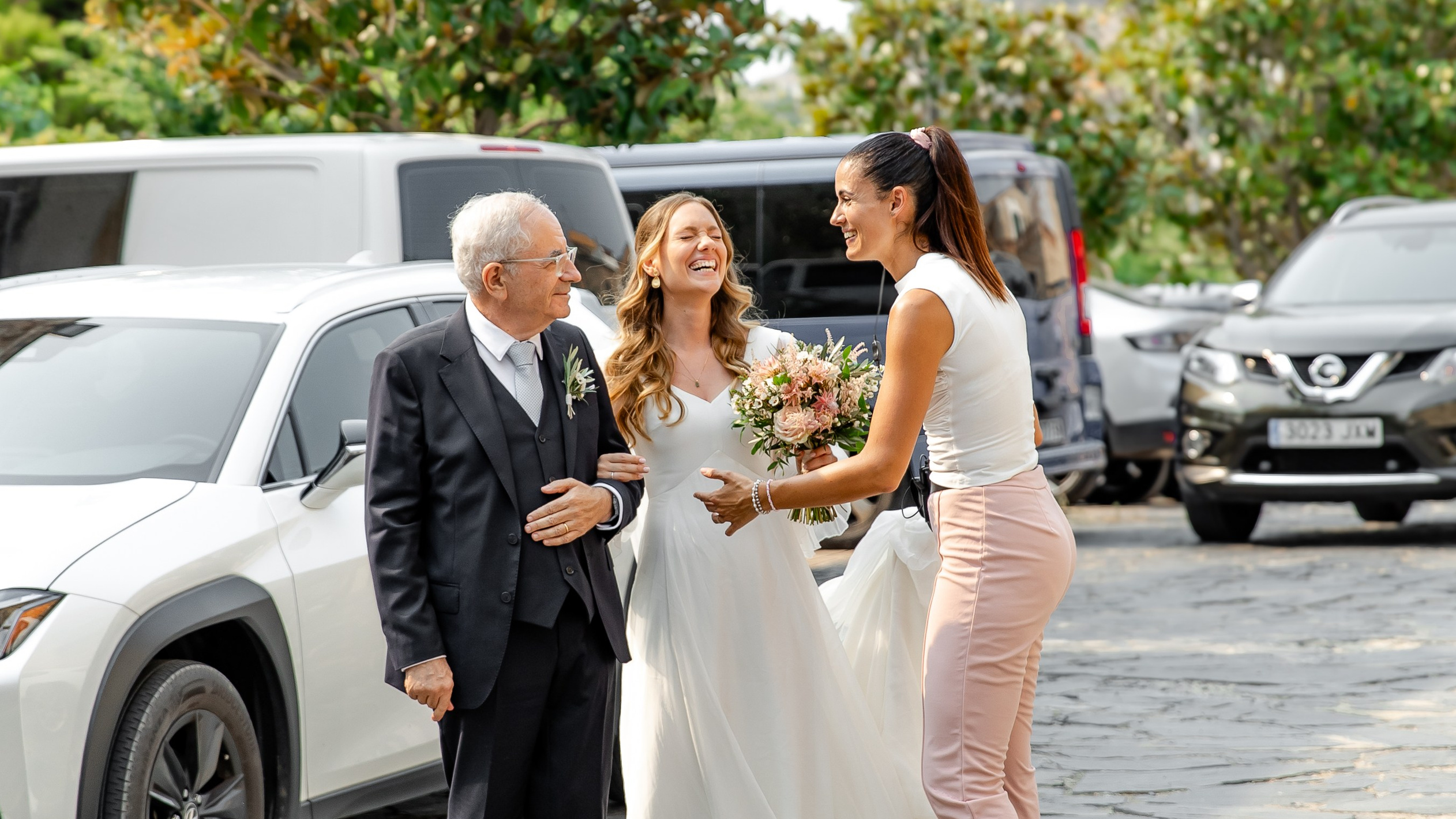 A wedding planner calms down the bride before she walks down the aisle at her destination wedding in Sitges, Barcelona