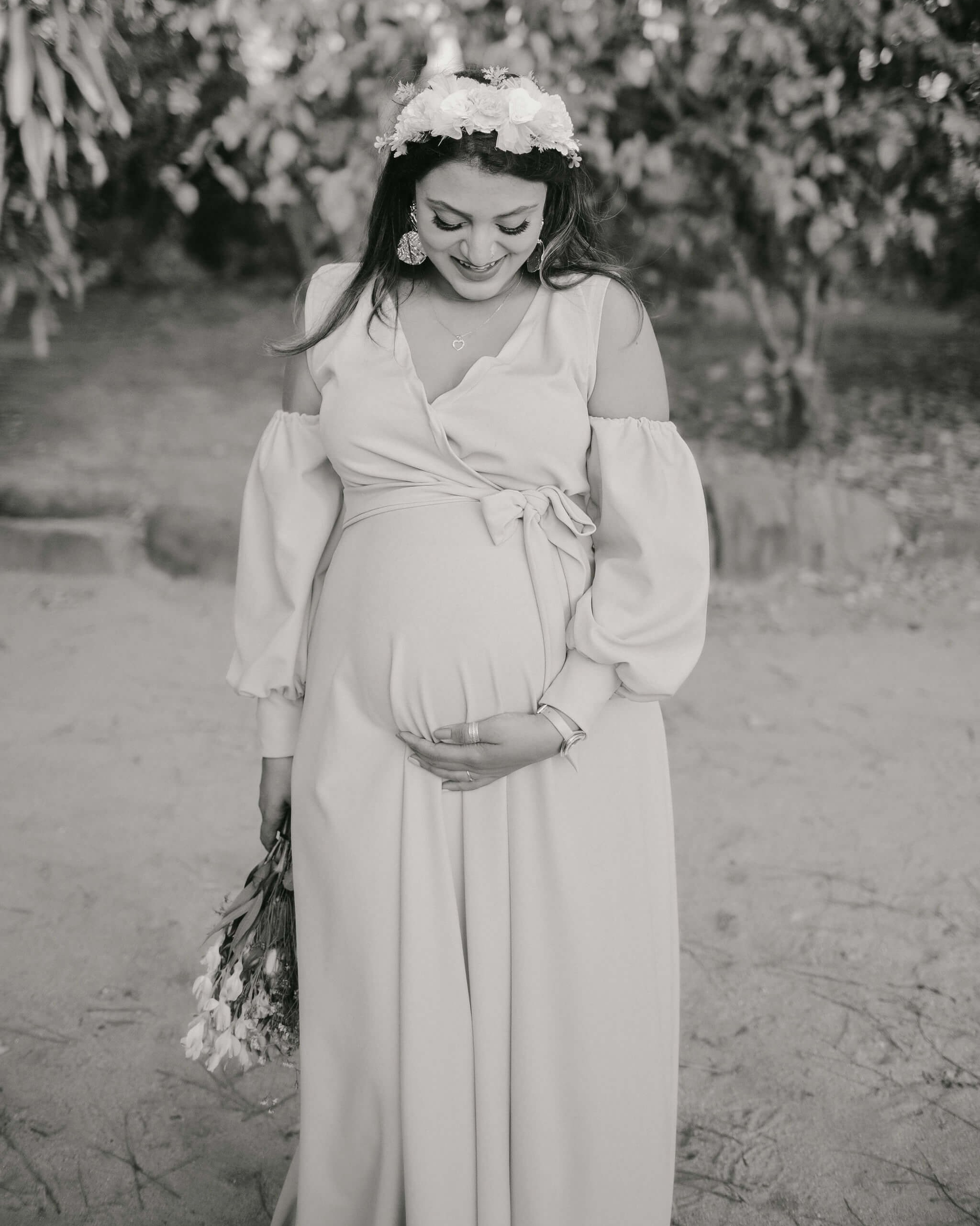 Peaceful maternity portrait in B&W, highlighting mother’s strength and softness in Mombasa beach garden.