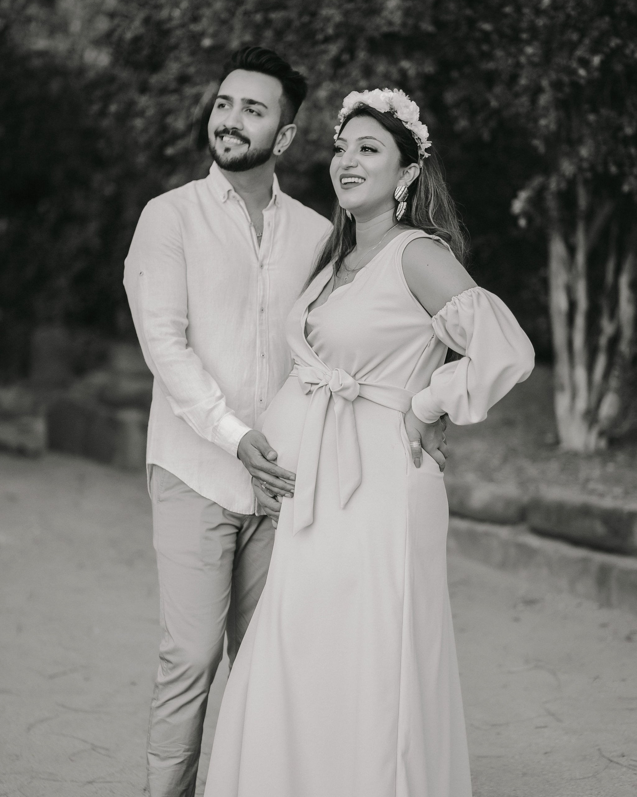 Joyful maternity session moment — husband playfully leading pregnant wife, classic tones, Mombasa, Kenya.