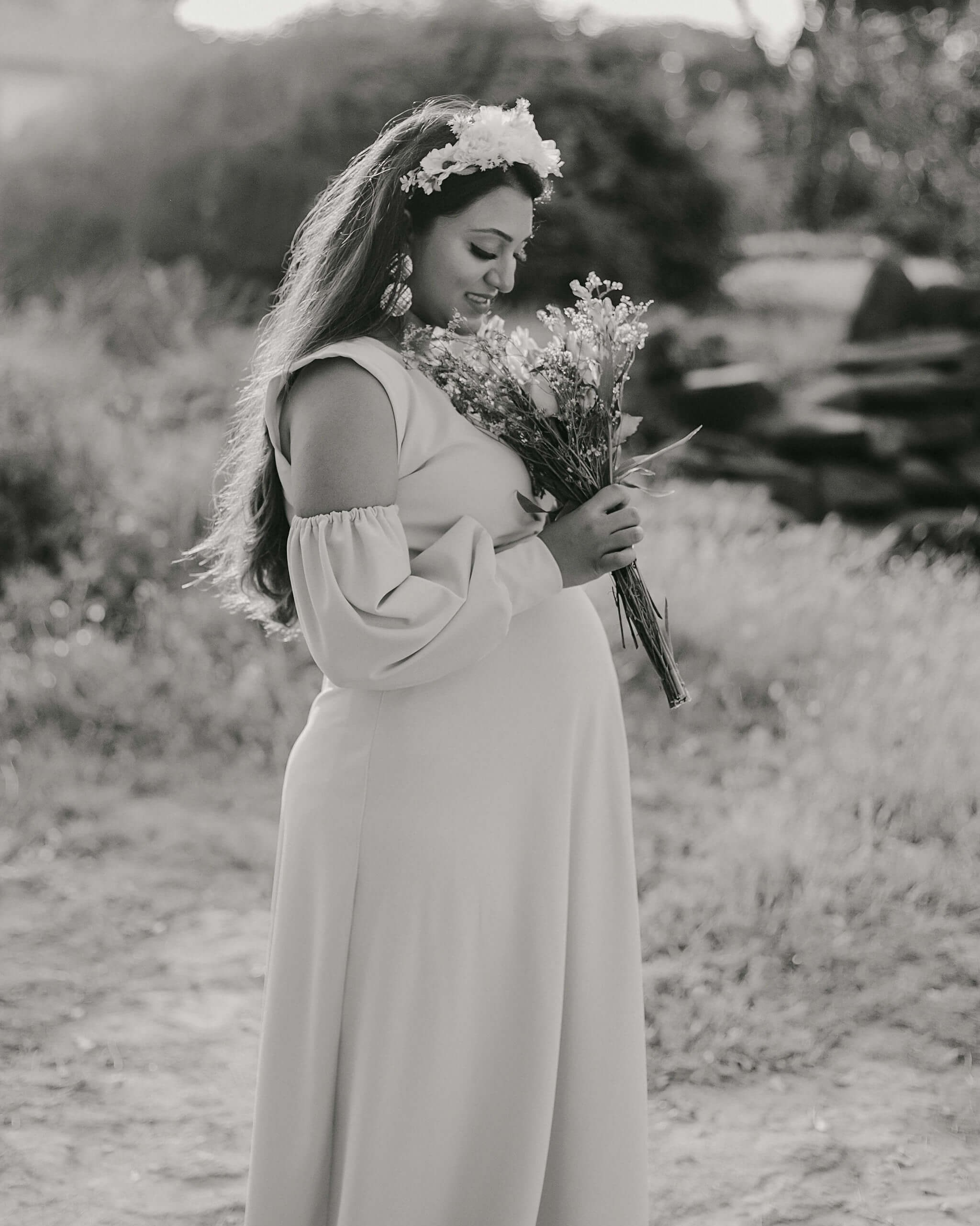 Kenyan maternity garden shoot with mom in boho gown holding belly, styled for classic album.