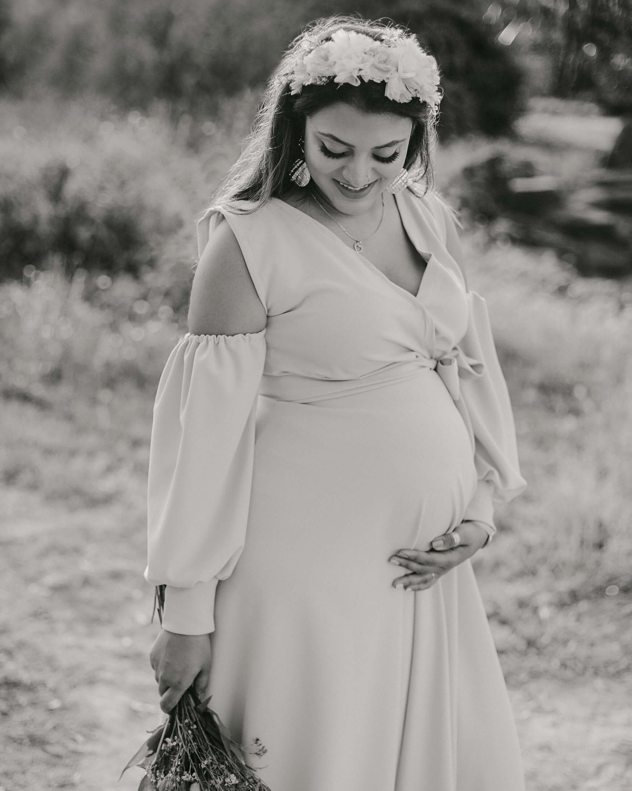 Full-body vintage maternity portrait in Mombasa, Kenya garden, mother standing gracefully in flowy dress.