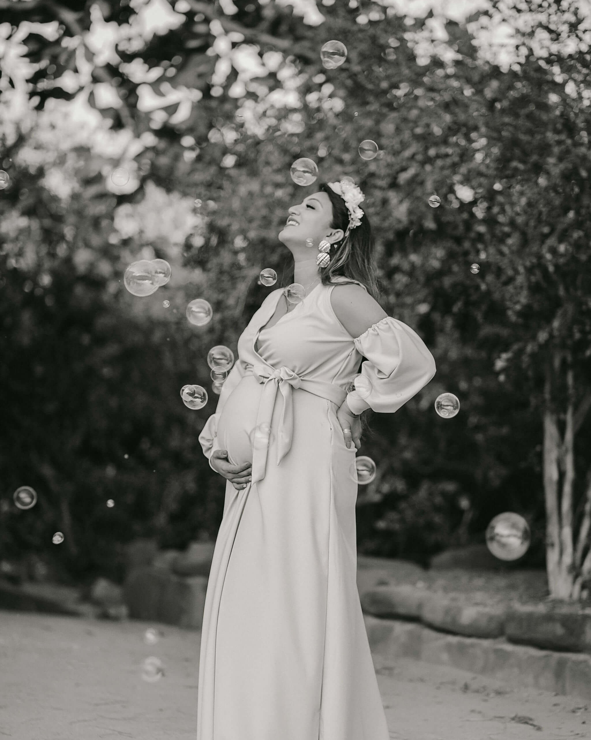Romantic garden maternity session in Mombasa — soft black and white tones add vintage touch.
