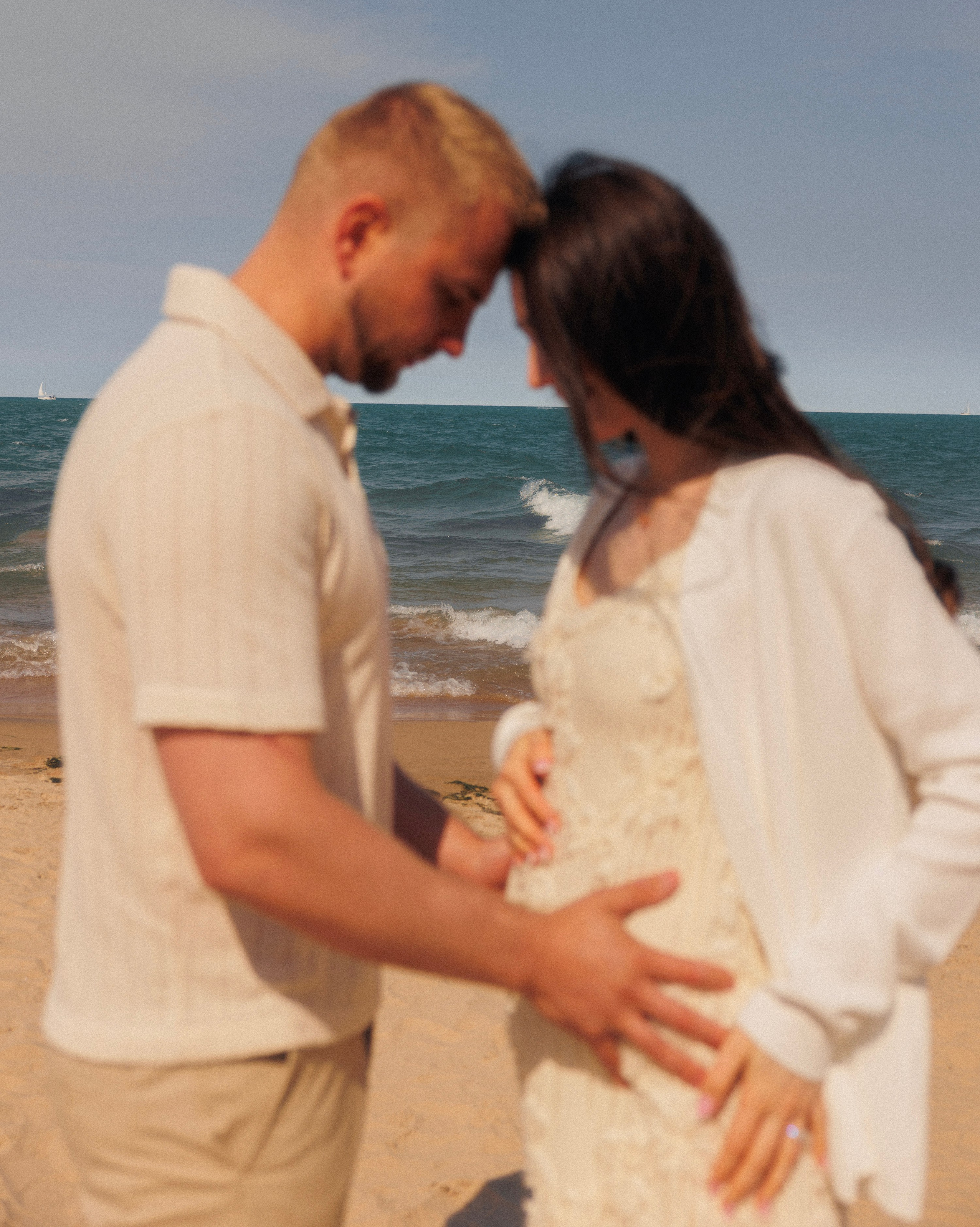 Pregnant woman holding belly in soft natural light