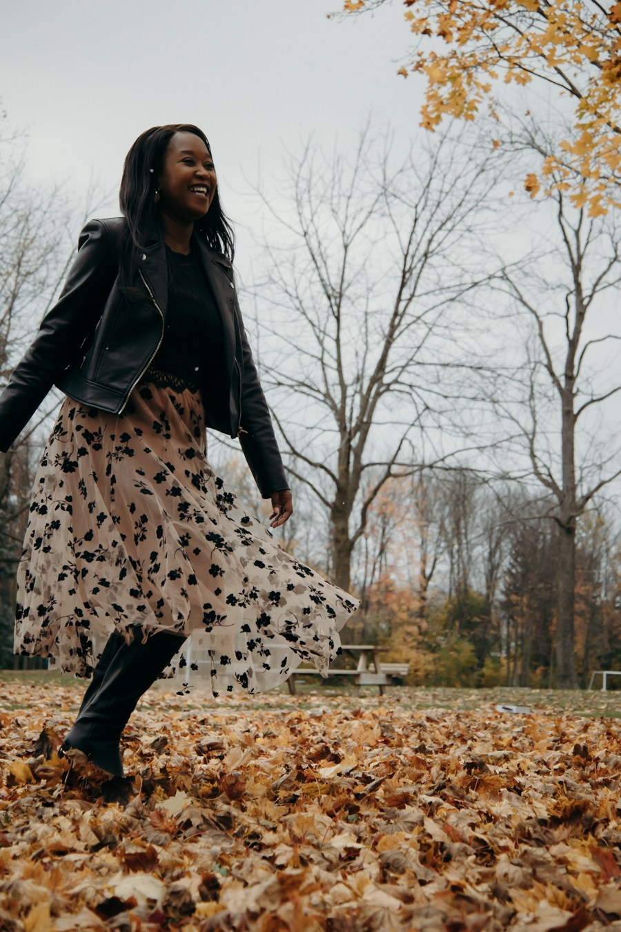 Child walking through autumn leaves during a Calgary family photography session