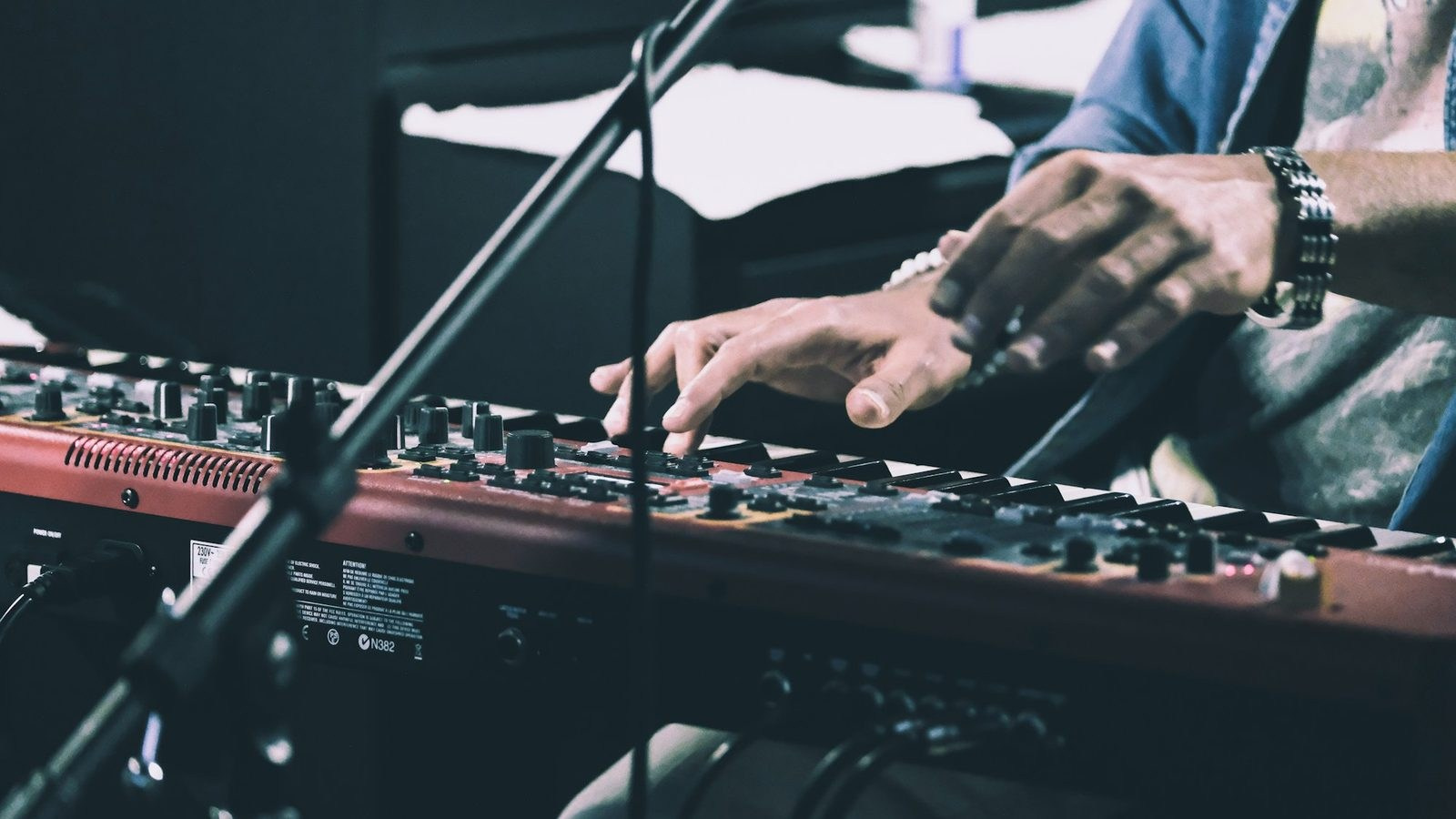 Audio engineer operating a sound mixer during a professional recording