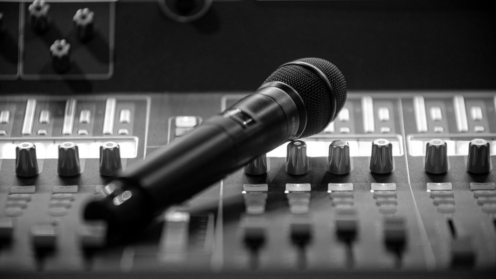 Microphone positioned on an audio mixer for podcast and interview production