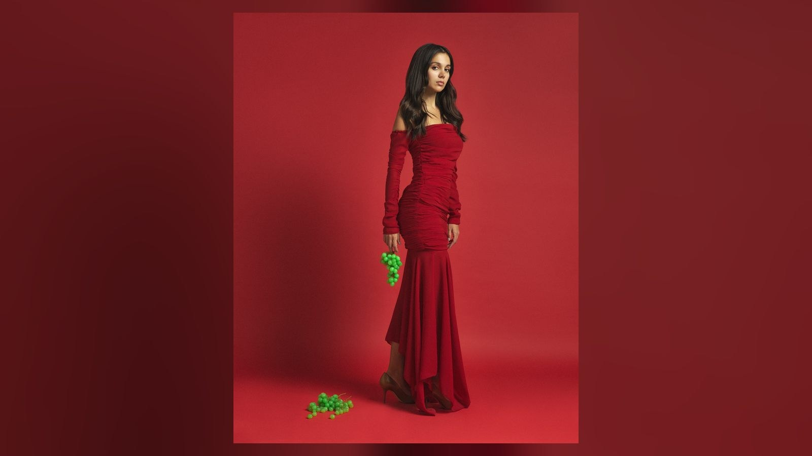 Red dress photographed against a matching studio background for a UAE fashion campaign