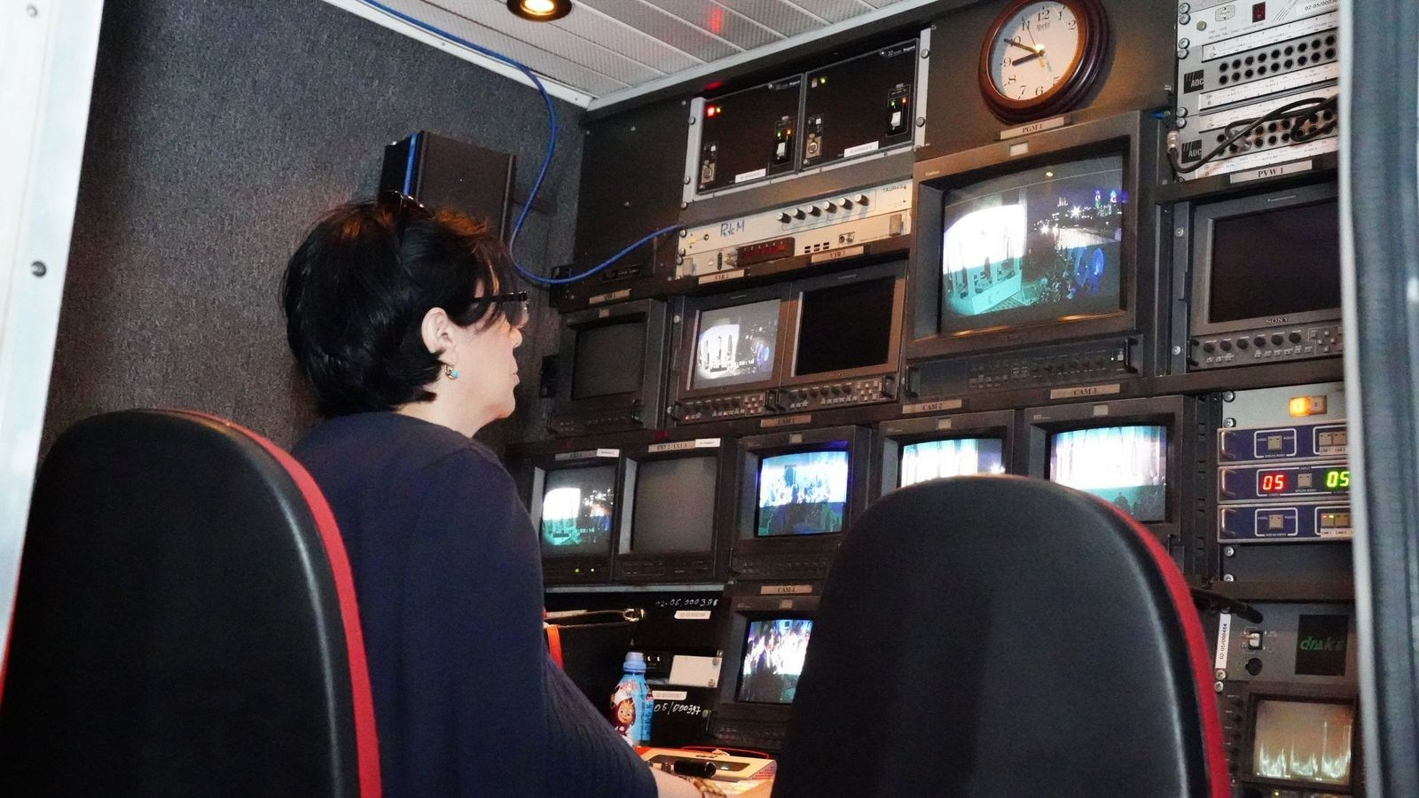 Broadcast operator monitoring live and recorded video feeds in a control room