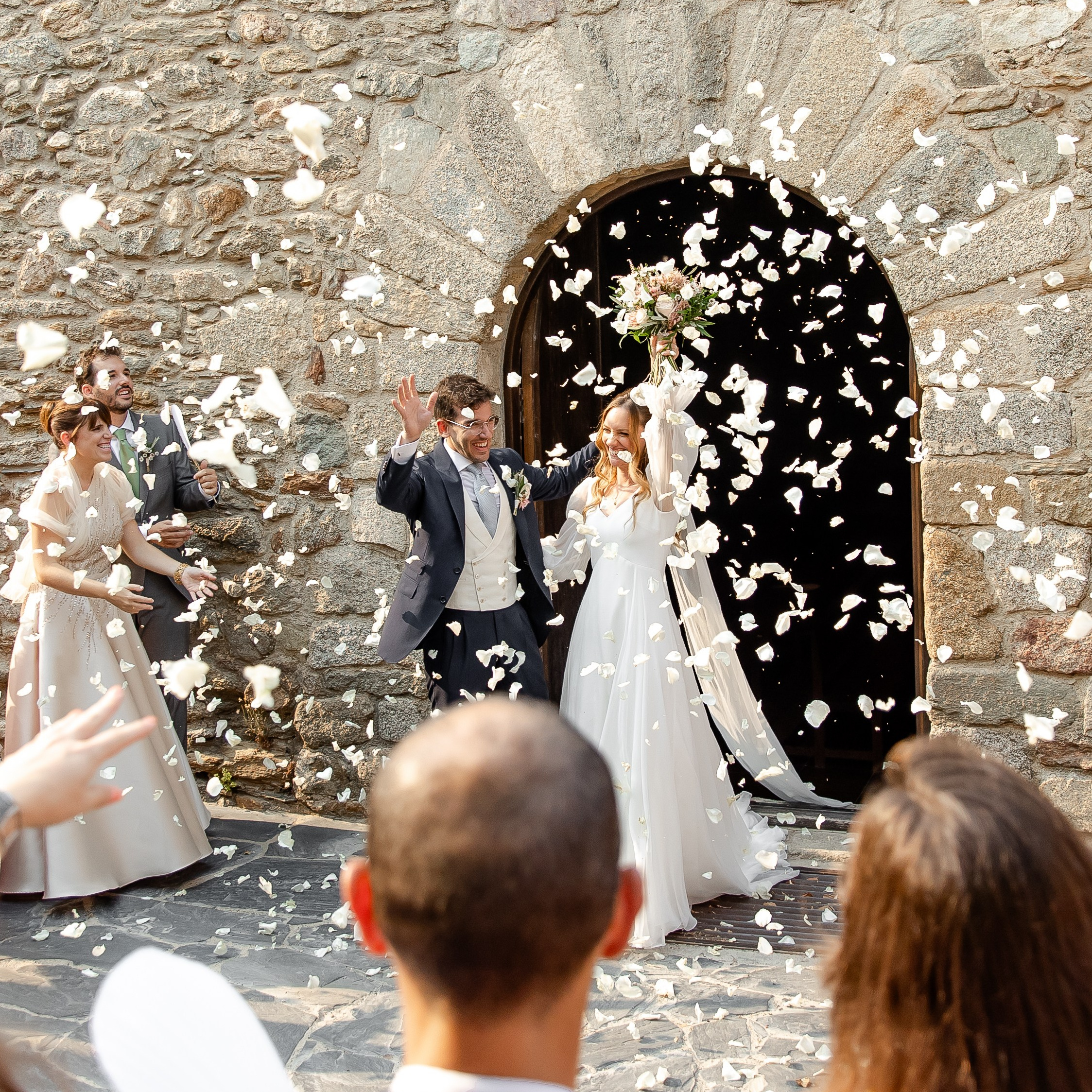 The bride and groom leaving the church after the religious ceremony in Girona