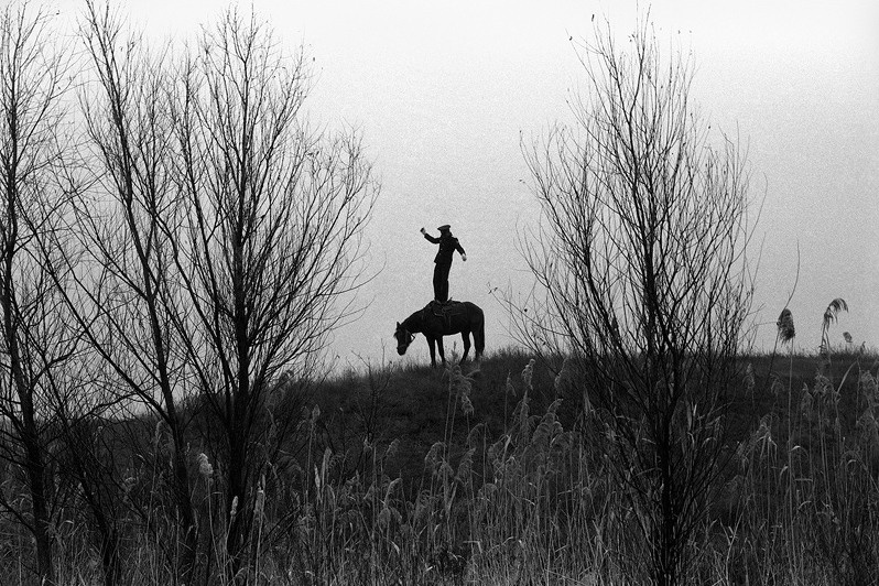 Cossack Valerka. Standing in all growth in a saddle | farm of Senshin, village of Oblivskaya district, Rostov-on-Don region, Russia, 2010