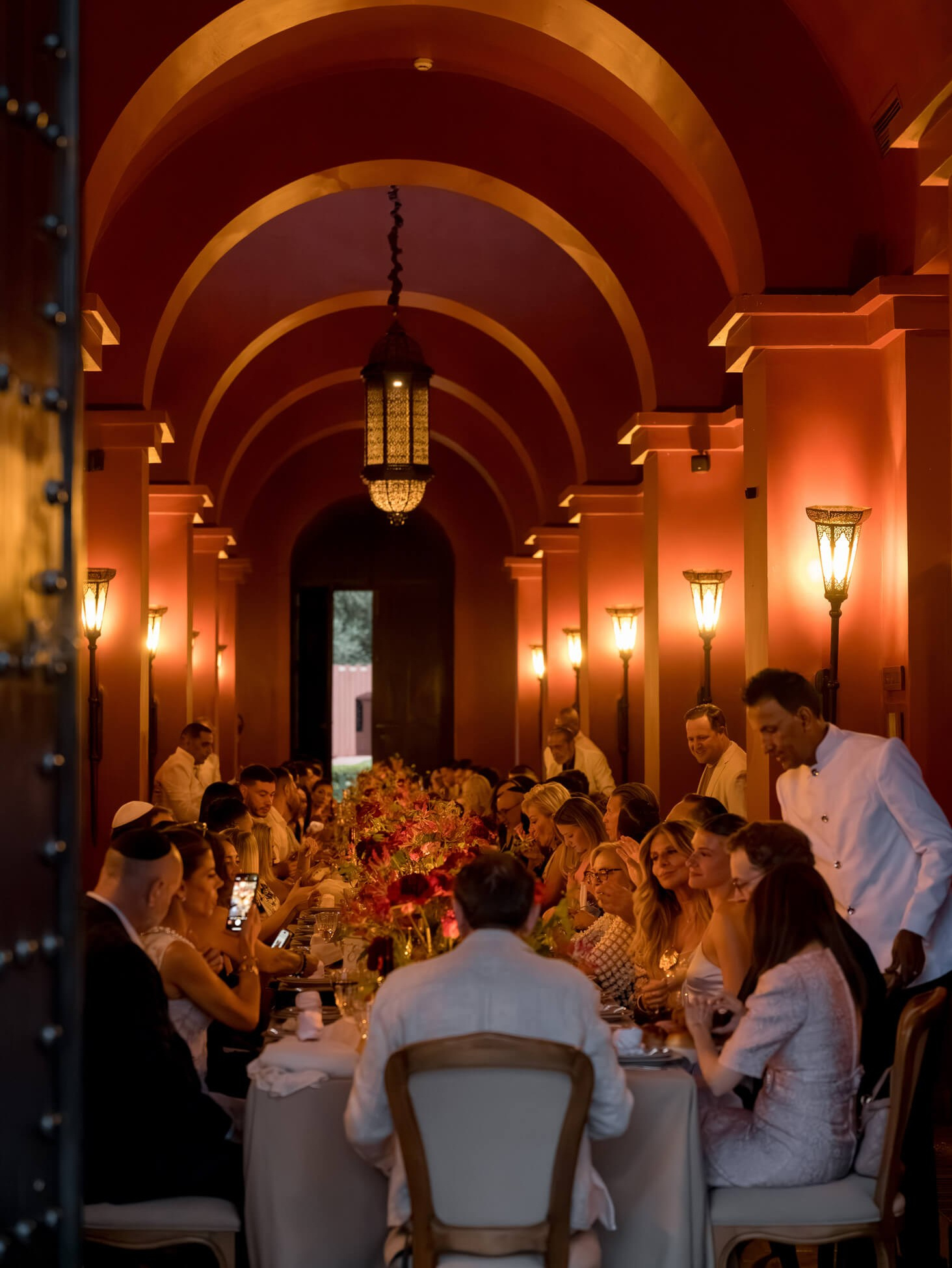 Luxury wedding dinner in a candlelit hall with arched ceilings in Marrakech