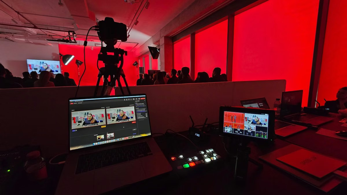 Professional live streaming setup with a camera, video switcher and production monitors at a corporate event in Dubai