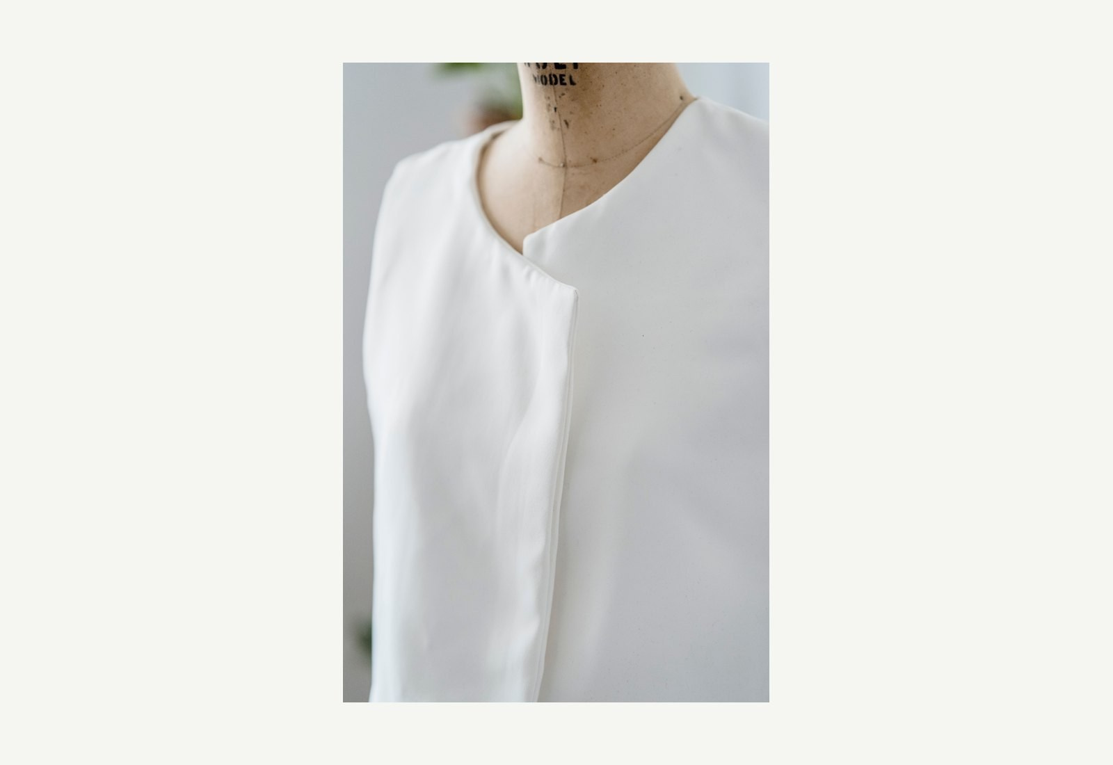 White garment displayed on a dressmaking mannequin