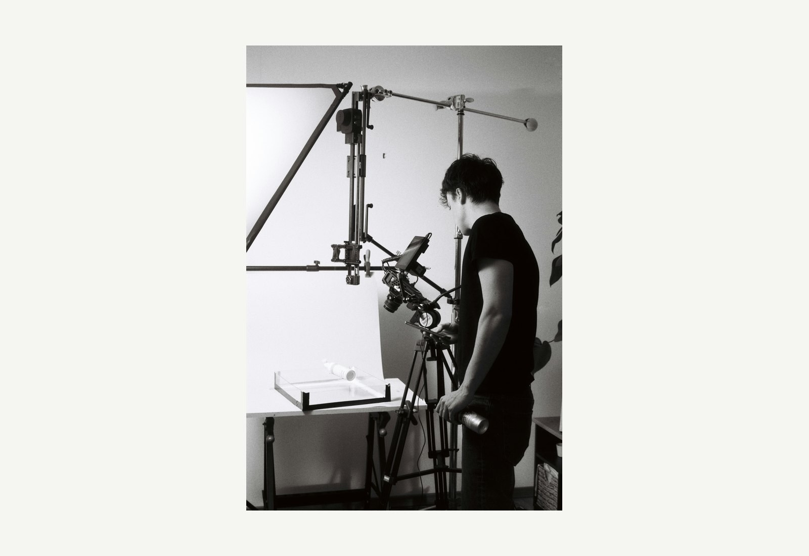 Camera operator preparing a product video setup in a professional studio