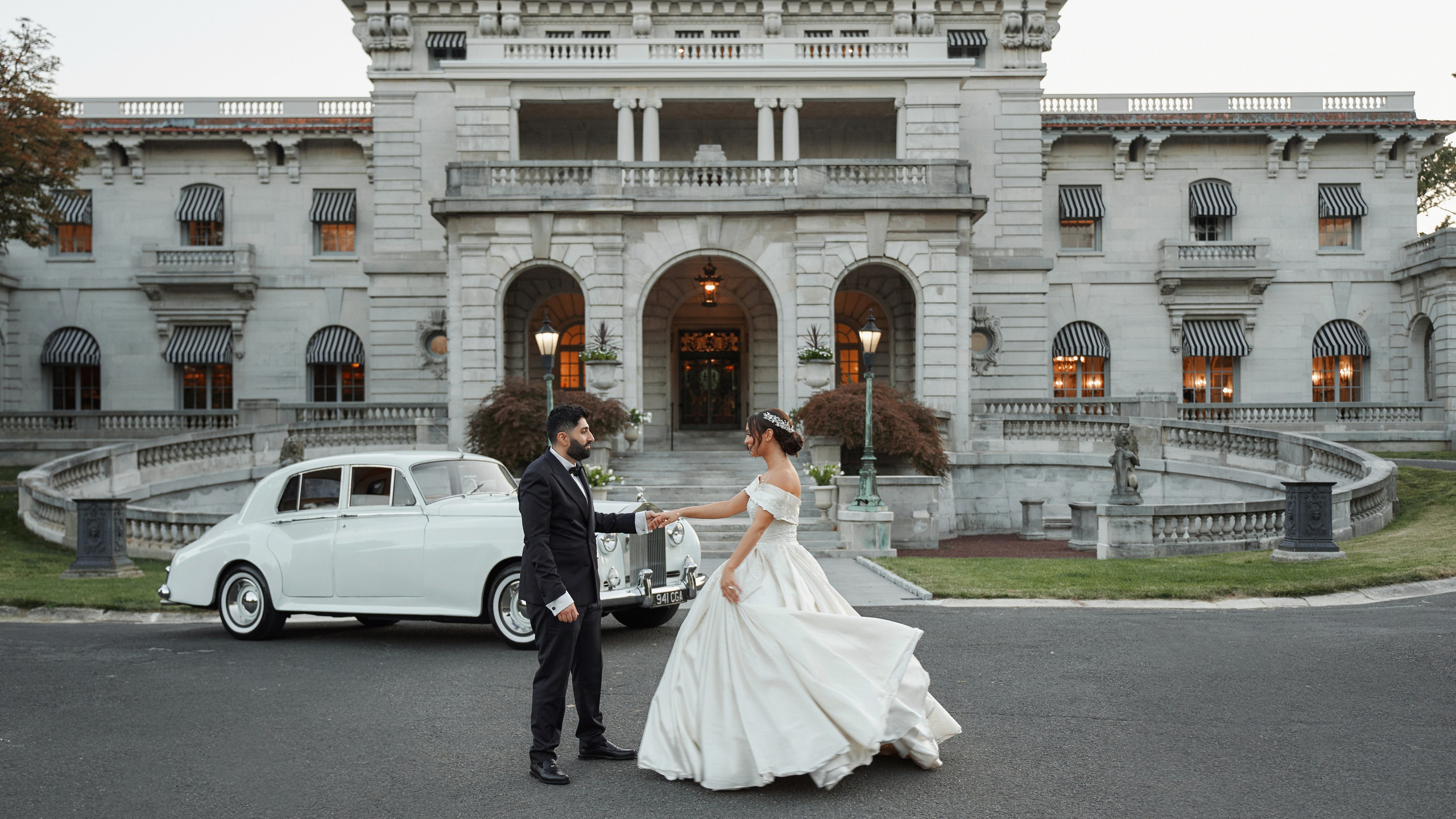 Bride and groom wedding portrait in front of historic mansion and vintage car in New York