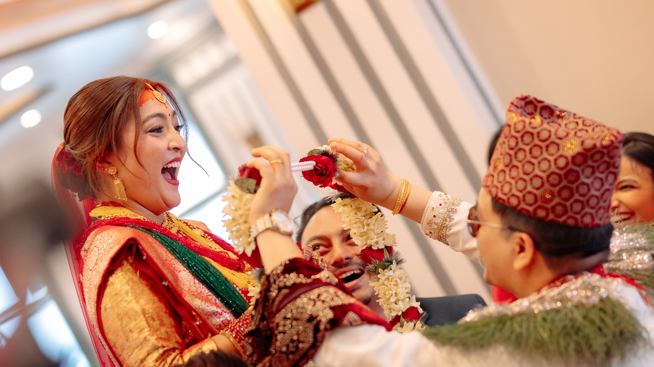 Candid moment of a happy Nepali bride laughing during barmala ceremonyin Kathmandu Nepal.