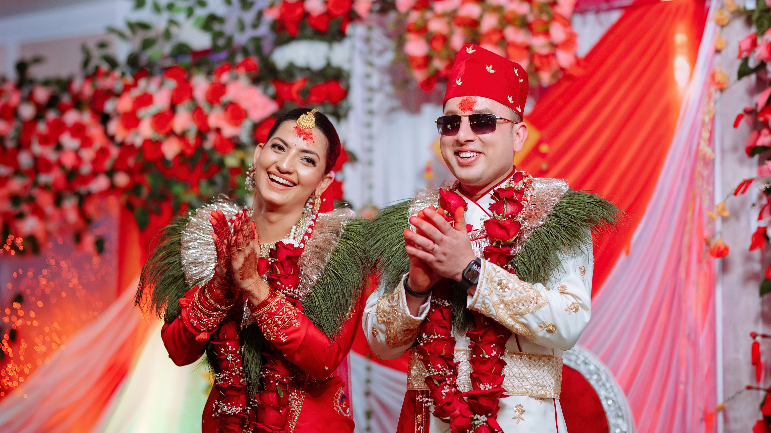 Happy Nepali bride and groom clapping on stage AT wedding ceremony, premium wedding photography in Nepal.