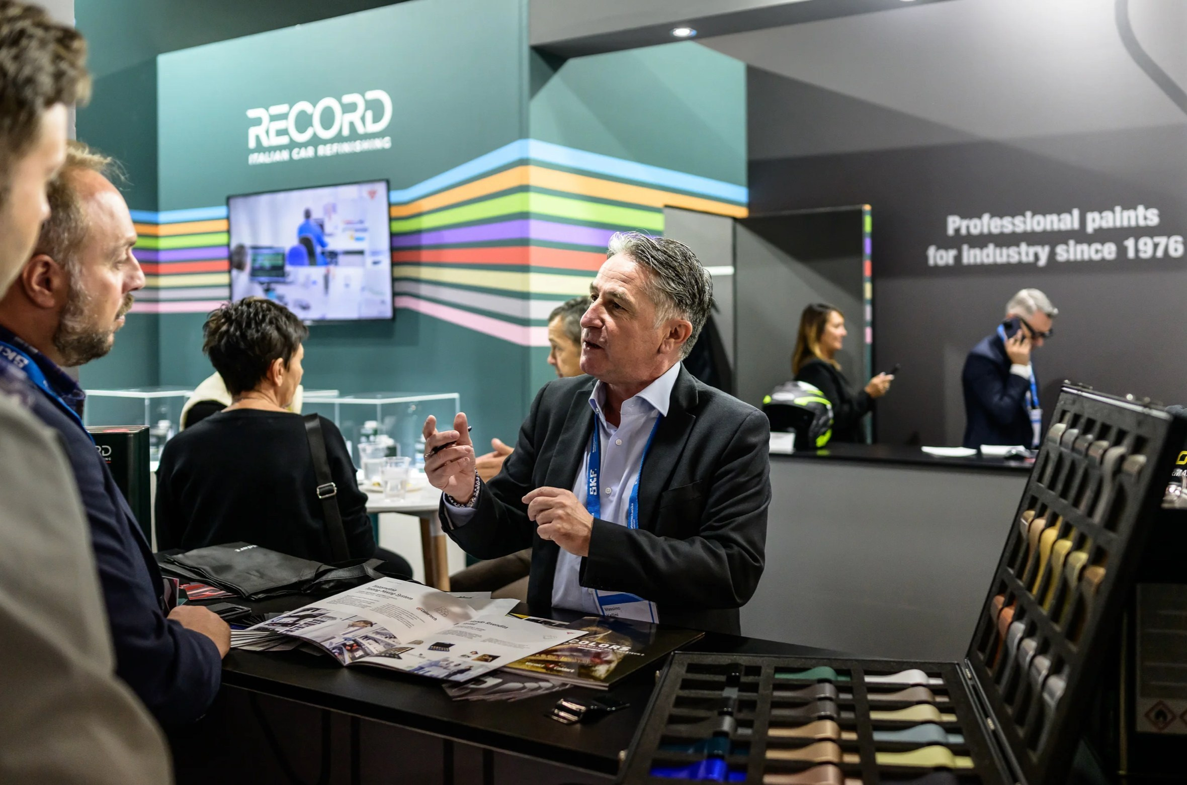 Business professionals networking at an exhibition stand during a corporate event in the UAE