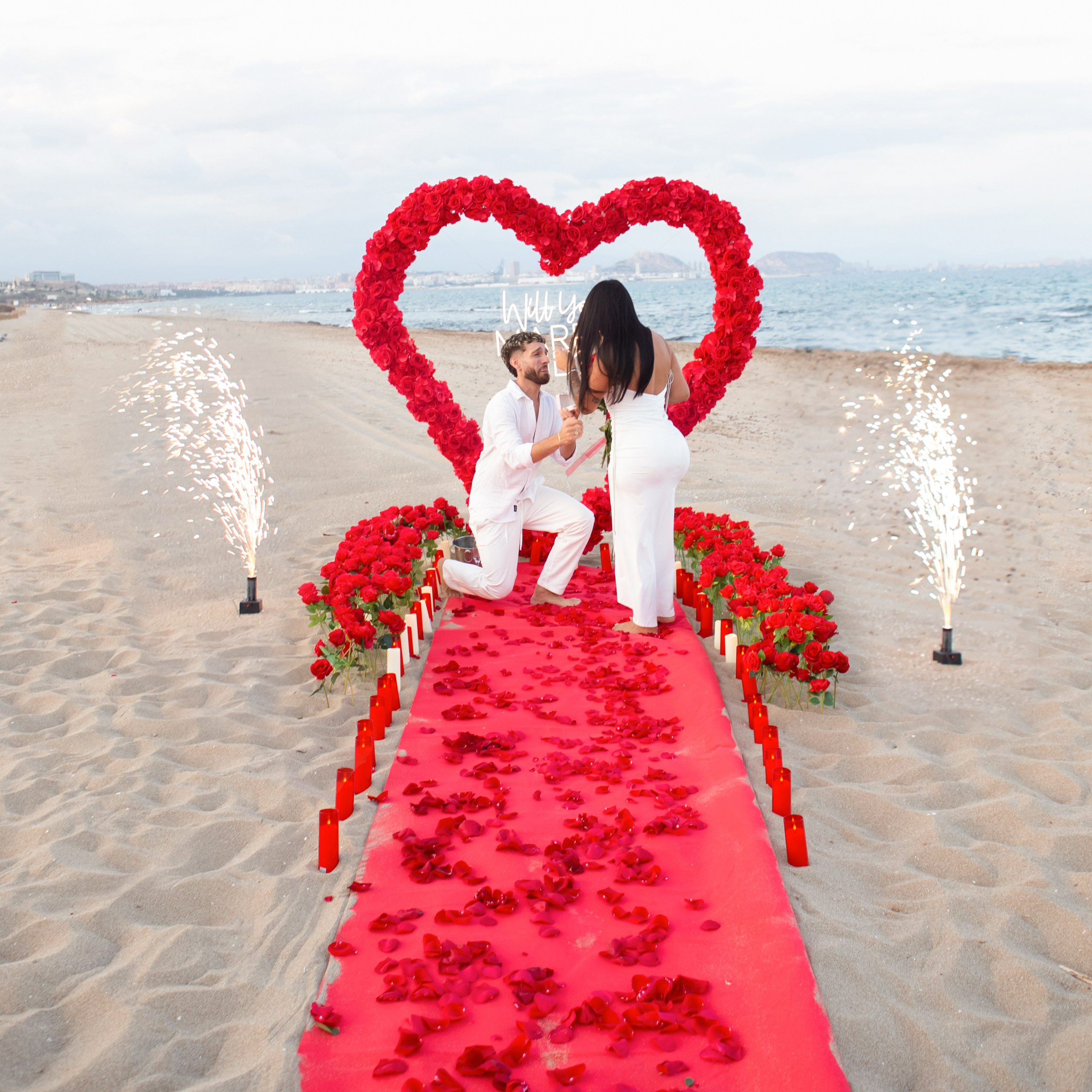 Romantic beach proposal with a red heart decoration and live saxophone music on the Costa Blanca coast