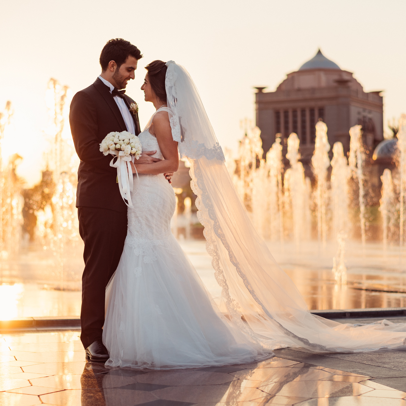 coppia degli sposi davanti palazzo al tramonto in Dubai.