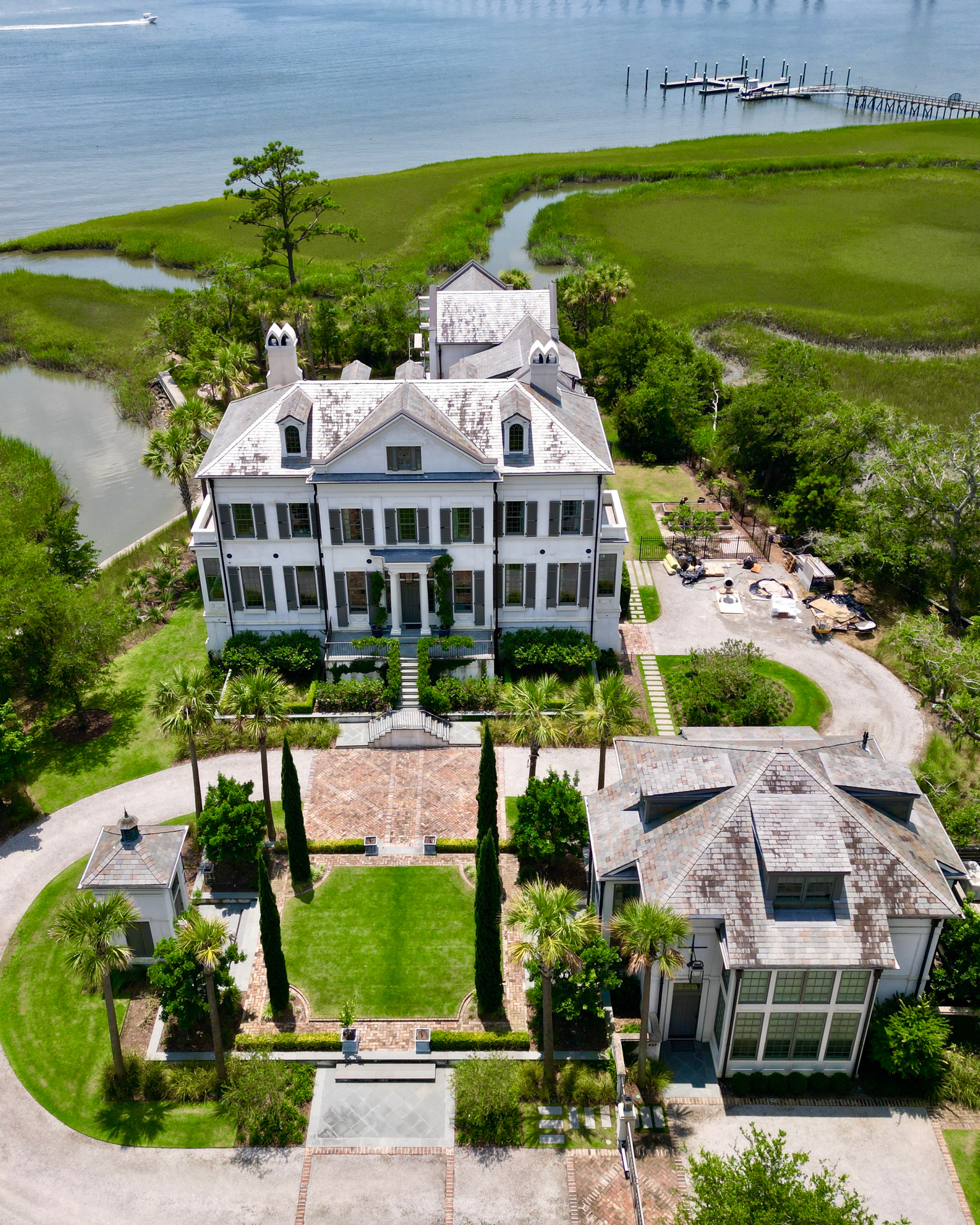 Drone capture showcasing a luxurious mansion overlooking the waterfront.